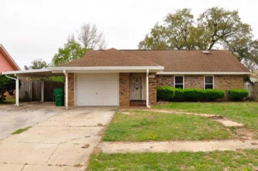 REO. Fantastic deal west of Hurlburt! Home features an enclosed 320 square-foot Florida room (not included in square footage) that has an AC window unit (SOLD AS IS). Inside the home you will find both a cathedral ceiling in the living room and a brick fireplace. The kitchen overlooks the living room and features a dining area right next to it. Kitchen comes equipped with a French-door refrigerator, stove, microwave, and dishwasher, as well as a breakfast bar. Wood laminate flooring can be found in the living room, dining area, and two of the bedrooms. Home boasts a 1-car garage, as well as an attached 1-car carport. Hurlburt Field is just a convenient 15-minute drive away! Home being sold AS IS.