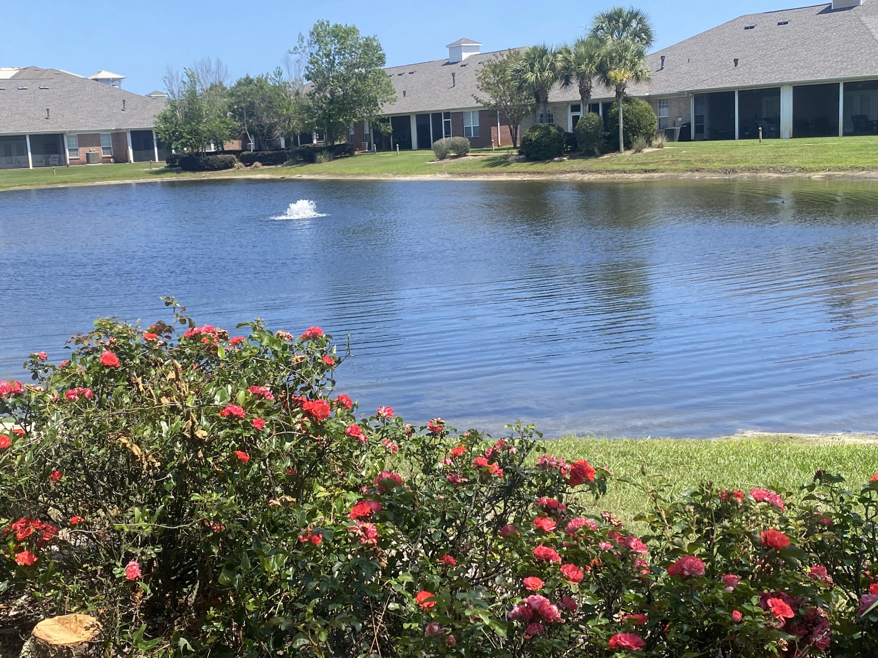 Spacious, Super nice, one level waterfront townhome with great views! Diamond Lakes is a quiet, peaceful neighborhood featuring a fishing pond, lovely pool, sidewalks, street lights & underground utilities. The entryway opens up into the large Living/Dining area with vaulted ceilings, Gas Fireplace & French doors leading to the screened patio. Here, relax with your morning coffee or afternoon cocktail overlooking the pond and listening to the water fountain - truly a tranquil retreat away from it all! The huge Master Suite, has a big walk in closet, Jacuzzi tub and separate Shower. Henderson State Park and the beautiful Beach are less than a mile away, with shops and restaurants even closer! NEW Roof & newer HVAC. HOA covers landscaping inc. yards, termite bond, trash & recreation.