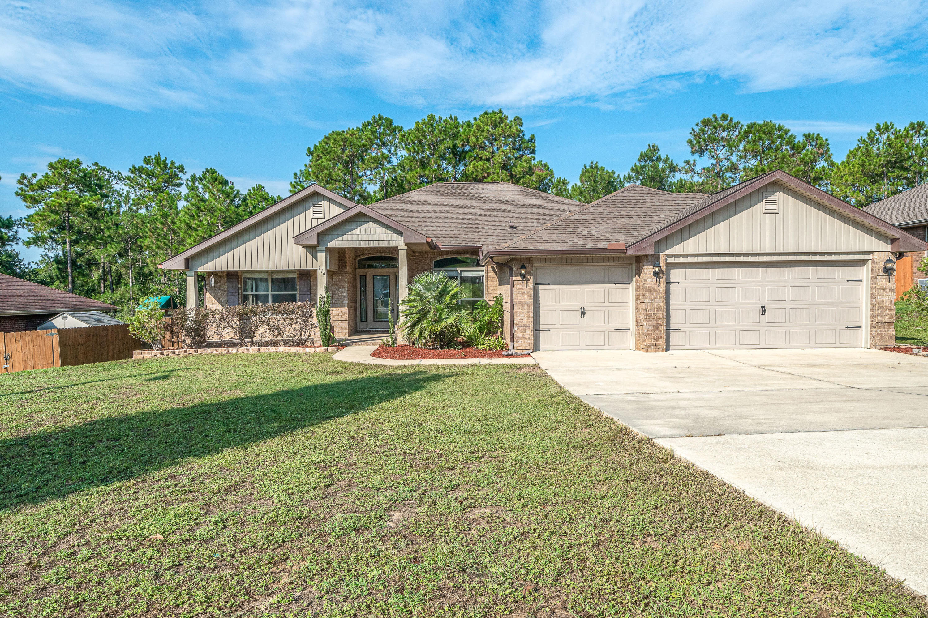 Come experience this freshly painted in ''Agreeable Gray'' 4 Bed/3 Full Bath/3 Car Garage all brick home located in sought after Alicia Place - South of I-10 with short commute to 7th Grp, Duke, Eglin AFB. The property welcomes friends and guests alike with a covered front porch. As you enter home you will notice the 10' ft ceilings, open concept dining/family room/kitchen area with access to a large covered back porch perfect for entertaining. There is a large flex room that could easily be used for office or kids play area. The kitchen features plenty of cabinets and countertop space for meal prep, stainless steel appliances, and breakfast bar. The spacious master suite features treyed ceilings, separate closets, separate vanities, stand up shower, and garden tub. The additional