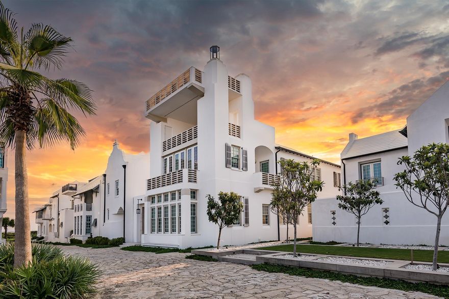 A gathering place by the sea shared freely with friends and affectionately named Casa Floridoro after the chivalric poem. This magically designed home by Khoury Vogt Architects, the firm led by Alys Beach Town Architects Marieanne Khoury-Vogt and Erik Vogt were given simple instructions...make this your greatest design. Water & Fire strategically orchestrate the elements found in Casa Floridoro. Top to bottom, water & fire the theme. Just one-and-a-half blocks from the Gulf, the home anchors a prominent axis at the south end of a grassy park known as The Parterre alongside Sea Garden Walk leading to the Gulf of Mexico. Overlooking the park, intricate details effortlessly flow on every floor and in every fixture, finish, and furnishing of the four story, four-bedroom home. The water and fire are apparent immediately when entering the courtyard. The Zaguan walls of rough-hewn Italian limestone with flowing water trickling down provides a feel of serenity. A "firewall" arrives next, with gas lanterns and solid Italian limestone urns in a shelf pattern that climb high into the night, creating a dramatic image of dancing flames and shadows at dusk. A floating gathering pavilion suspends from stainless rods seamlessly to the negative edge pool extending around the corner with a Sylvester palm tree that appears to float on water. Stepping inside the home, the first floor is mostly a large gathering space of gourmet kitchen, living, and dining overlooking the courtyard through the sliding door system joining indoor & outdoor spaces. The living room ceiling is coffered, featuring curved inlays of crafted wood in a raised pattern that repeats throughout and allows for the integration of home infrastructure such as ventilation grilles, sound system, and lighting. A long banquette offers comfortable seating across two separate custom dining tables with an inlay of antique mirrors. Crystal chandeliers adorn the wallsa choice that the owners made through deliberations with interior designer Susan Smith of Bohlert Massey Interiors. Italian limestone is used extensively throughout the four-bedroom, four bath home with two elegant powder roomspart of the owner's desire for very minimal maintenance. On the first floor it appears as large limestone floor tiles in a smooth velvet finish. In the courtyard are textured limestone pavers, while limestone railings on upstairs loggias feature a striated finish that adds visual interest. The thoughtful details are evident with every step, from a first-floor powder room with an internally lit onyx sink, to a white metal stairway handrail that looks like thick curving rope, all the way to the elaborate spiral chimney extending above the roof to offer a gift to the town's skyline. On the second floor, the master bedroom includes a large scene of tropical vegetation etched in light green glass covering the wall above the bed. Windows with views to the town surround the shower and bathtub, with privacy from curtains of stainless-steel beads. Intricately detailed, the master bath is complete with 1st class design & 5-star amenities including the automatic tub filler which flows from the ceiling with the champagne refrigerator within reach. The second floor offers the last two guest suites each decorated with its own identify and custom furnishings.  Both yield en suite bathrooms and private viewing balconies for each enabling the utmost guest experience. The large sky loggia on the third floor is a hub for entertaining and overlooks Sea Garden Walk with views of the Gulf. Designer driven comfortable furniture, bead curtains that can be released for privacy, and a weathered wood chandelier that casts intricate patterns on the Venetian Plaster walls complete the space. The home rises one more floor to the sky terrace, accessed by an expansive flight of Italian stone stairs that appropriately named "the stairway to heaven." The terrace cantilevers out from the home and appears to hover above the town, delivering some of the most expansive views of Alys Beach  Gulf waters outlined by the clean white of rooftops and views to the verdant green tree line of pines to the north. A limestone firepit is surrounded by seating, making this the home's ultimate gathering spot and a favorite place to get together with friends on fall evenings to watch the stars and sunsets or even your favorite sporting event on TV while grilling on the sky terrace's summer kitchen. The spiral chimney cast in the sky is a hidden gem cascading from the home in the skyline.  This visually striking home is the result of a geometrical designed architectural masterpiece.