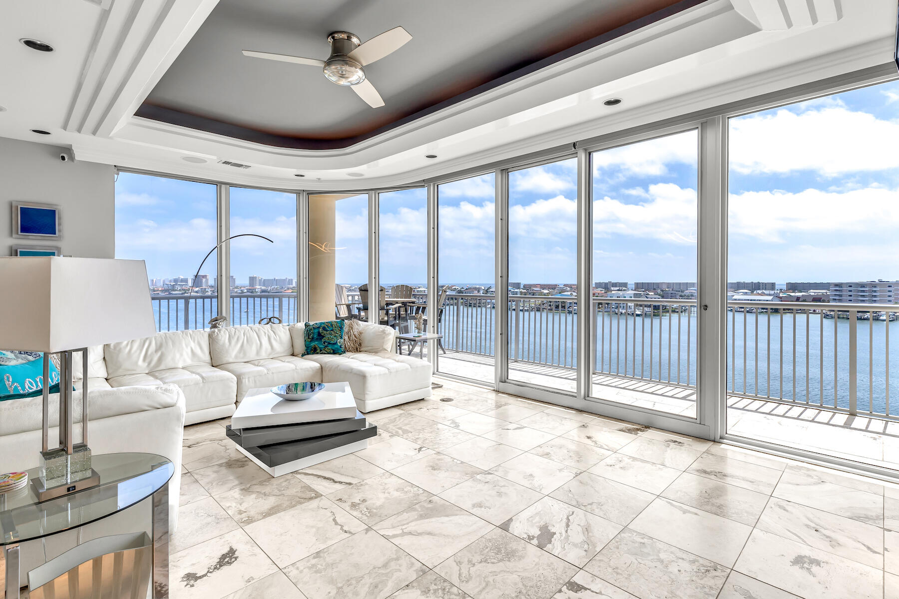 Come experience this contemporary three bedroom, three bath condo located right in the center of the Destin Harbor. With three balconies and floor-to-ceiling wraparound windows, this unit is a must-see for anyone looking for daily sunsets. The large wraparound 60-foot balcony provides spectacular views of the harbor, the Gulf of Mexico, and Destin's East Pass. This condo features an expansive, open floor plan with 2,265 sq. ft. all on one level. A custom spiral staircase leads to the private rooftop terrace with a summer kitchen and sunning deck...ideal for day or nighttime entertaining or simply relaxing in the privacy of your own rooftop space.