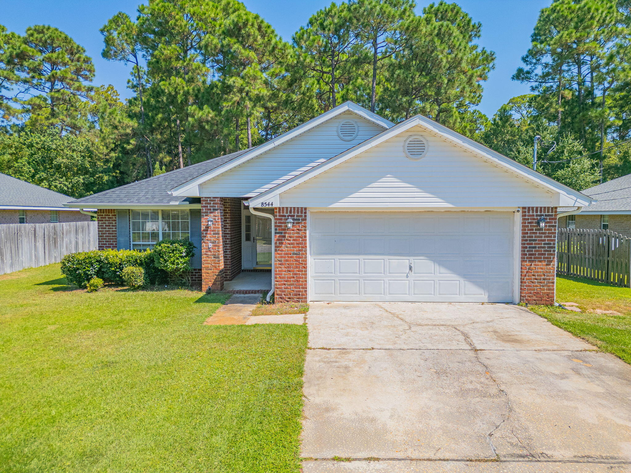 BEACH COMMUNITY OPPORTUNITY! Buy in Navarre! Great Primary or Secondary Home and/or Investment Property. No HOA! All Brick 4 Bedroom Home on a Cul-De-Sac Street. This low maintenance home backs up to a wooded conservation area allowing for privacy. Within miles of the Navarre Beach Bridge. Navarre Library is a block away. Near Hwy 87 with easy access to I-10. All the Restaurants, Grocery Shopping and Necessities are within easy reach. Roof and HVAC 2024! NO CARPET! FRESH INTERIOR PAINT. This wonderful layout affords privacy for everyone. Eat-In Kitchen and a Dining Room. Large Family Room. Inside Laundry. 2 Car Garage to store Water Toys and Lawn Equipment. Both Covered and Open Back Patio areas for Grilling and Bird Watching. MUST SEE! Buyer to verify all pertinent info