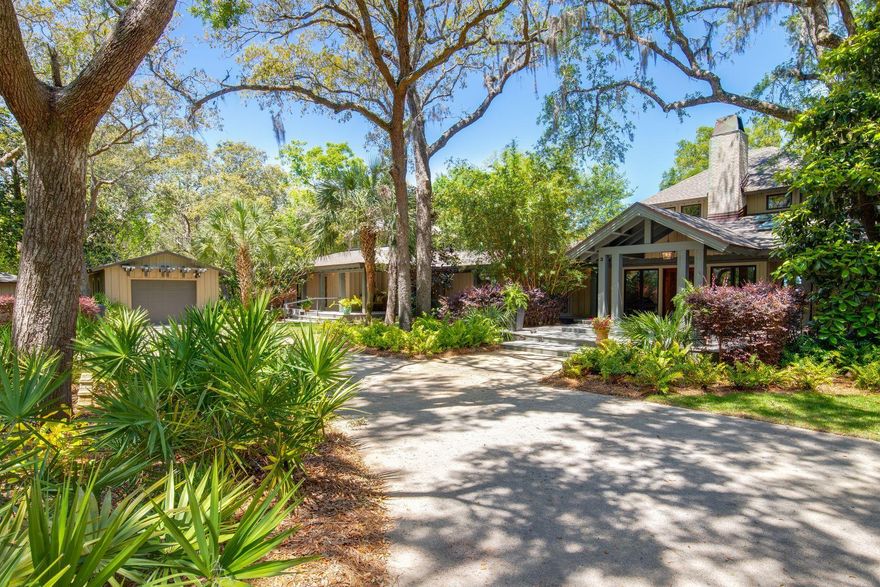 Situated beneath the sweeping boughs of mature oaks on its one-acre Bay-front site, this re-envisioned dwelling combines its traditional, Southern-style exterior with contemporary, well-sequenced living spaces. Rustic, natural elements such as rough-sawn, Cypress wood beams are incorporated with refined finishes and modern fixtures to create a harmonious atmosphere that is artistically composed and at the same time comfortable and inviting to live in. A dramatic wood-burning fireplace in the living room dictates flow from the main entrance into either the private master bedroom suite, occupying the east end of this single-level home, or the dining and living rooms. The master bedroom features views to the Bay and access to a tremendous, 16 by 36-foot screened porch.