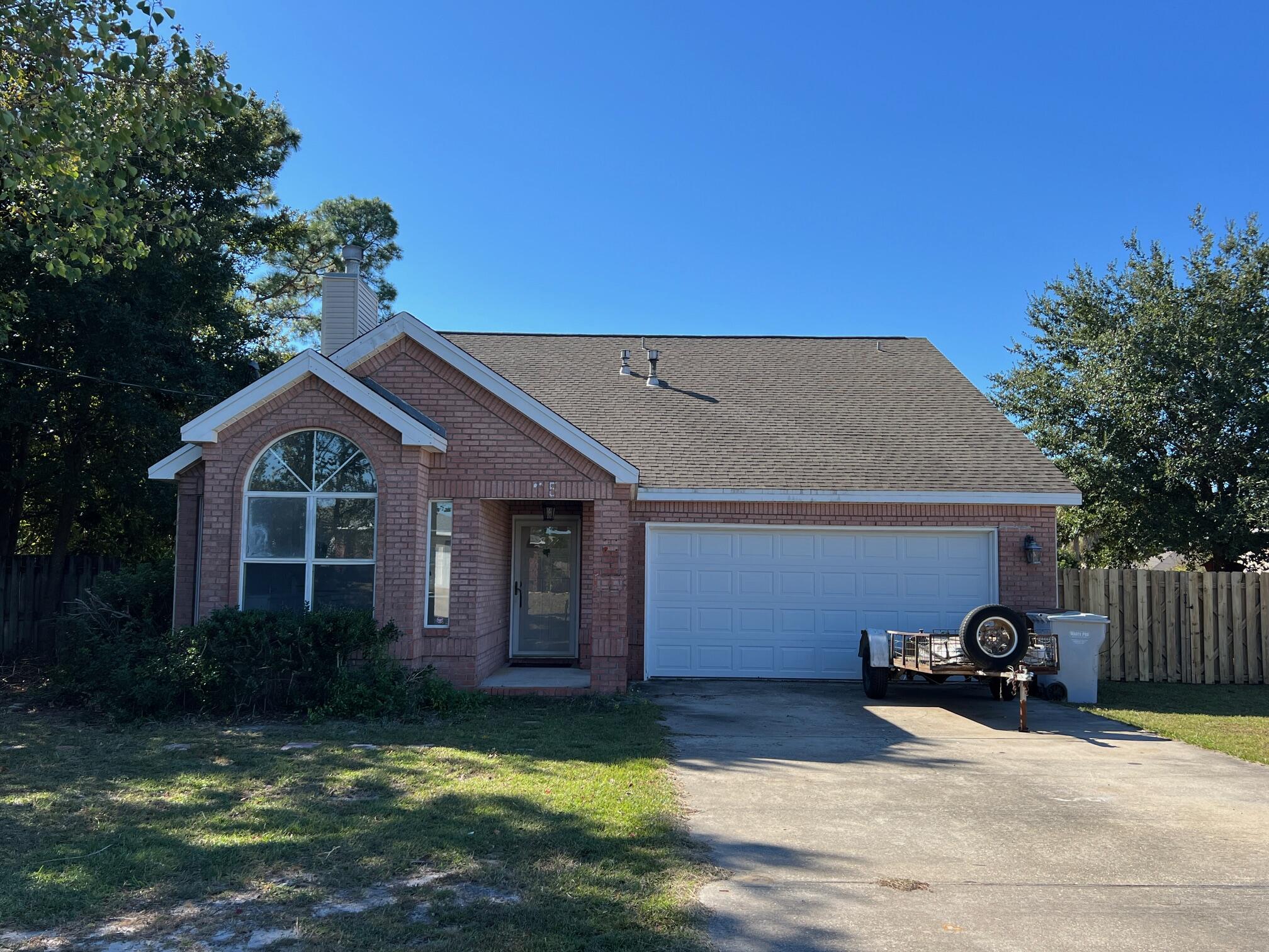 Fabulous Central Navarre Location - Just 5 Minutes from Navarre Beach! This spacious 1,718 sq. ft., 4-bedroom, 2-bathroom home is situated on nearly a half-acre lot with no HOA, offering privacy and flexibility. The property includes an impressive 600 sq. ft. detached building with two rooms, fully insulated for use as guest quarters, a workshop, a she-shed, or a man-cave - whatever suits your lifestyle!The oversized eat-in kitchen boasts modern touches including a gas stove, built-in microwave, new wood cabinets, solid surface countertops, and generous counter space, perfect for culinary enthusiasts. The large living room features a soaring 12-foot ceiling, stylish ceiling fan/lights, ample natural light, and a fireplace with a TV mount. French doors in the living room lead to the versatile 4th bedroom (bonus room) located upstairs, which provides access to a walk-in, decked attic - ideal for abundant storage. This 4th bedroom offers the extra space every homeowner needs! The Master Bedroom is on the 1st floor, along with two additional bedrooms and two full bathrooms. The master suite features a trayed ceiling, French doors leading to a screened porch, a luxurious updated bathroom with a step-in shower, new vanity, new LVP flooring, a walk-in closet, and a private water closet. The guest bedrooms are well-sized, equipped with fan-lights and ample closet space.
The property includes a spacious laundry room for added convenience. Outdoors, the expansive backyard with a wood deck offers potential for entertaining, relaxing, or future customization. Notable for its superior build quality, the home is framed with oak and the roof structure is reinforced with 2x6's, showcasing its solid construction. Recent updates include a 2024 hot water heater, newer HVAC system, and updated septic (2024). The two-car garage features one extended side to accommodate a truck.
This property is a rare find with space, versatility, and proximity to Navarre Beach. Call today to schedule your viewing of this wonderful home!