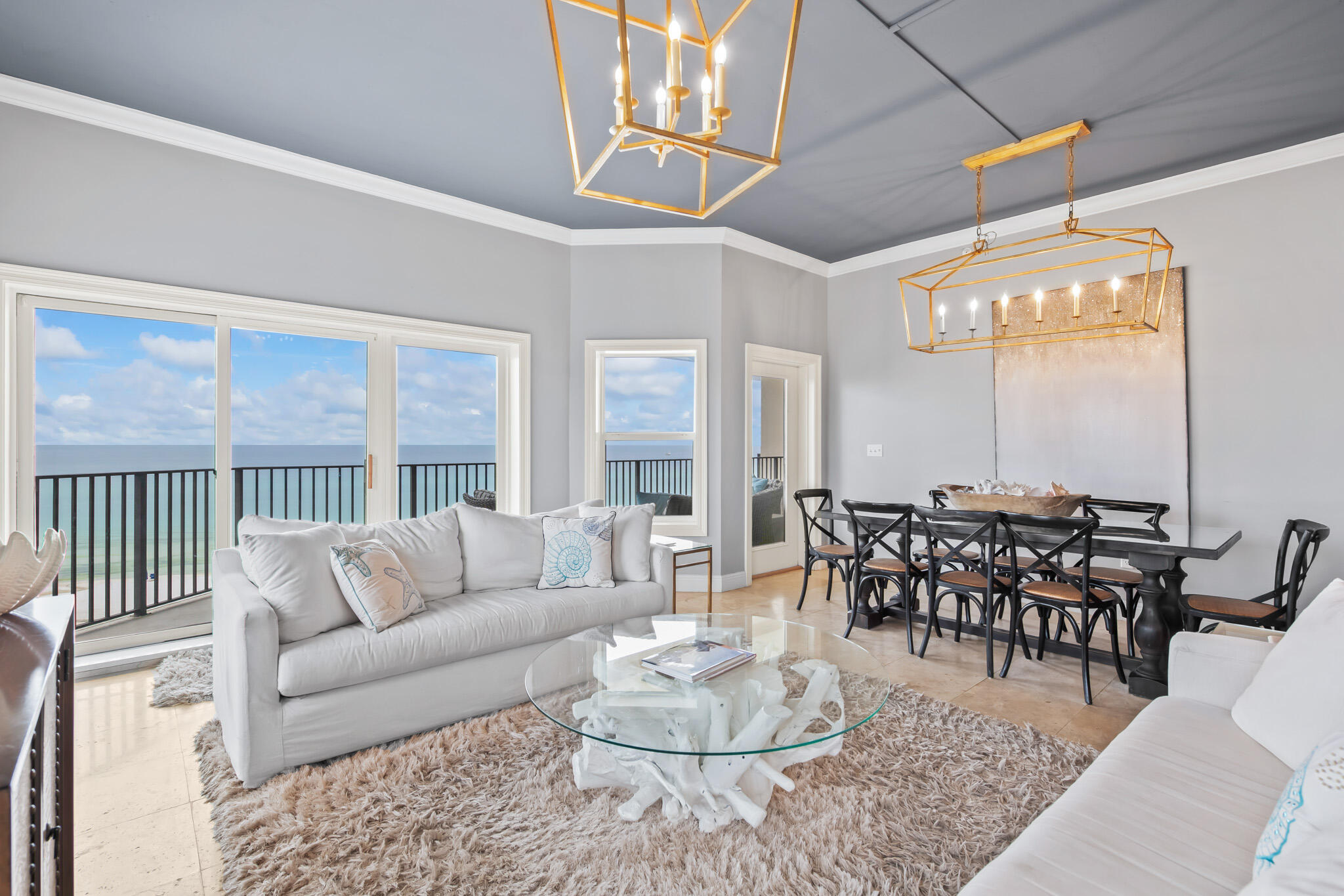 It's high-end coastal living at Seagrove Beach's The Legacy! This top floor, beachfront corner unit offers ultimate privacy from the rest of the world. Upon entry, you are greeted by its own foyer, leading up to the open living area. Relax in the spacious family room surrounded by ocean views, as well as the dining area, perfect for entertaining guests. Indulge yourself in the updated eat-in kitchen equipped with a kitchen island and stainless steel appliances. Soak in the flood of natural light while enjoying a glass of your favorite bottle from the wet bar.