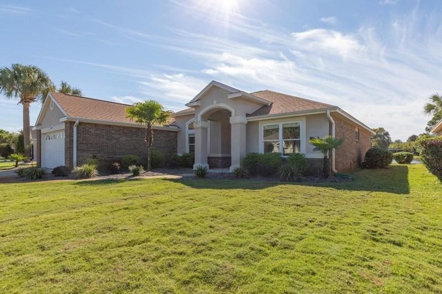 What is better than a move in ready renovated home with a pond view. This brick and stucco home has a 4 year old roof, split floor plan, natural gas furnace and gas fireplace. The windows are vinyl and double paned. Beveled glass accents on the front door and accent windows. Walk-in and notice the natural light in the home. Large living area, kitchen, and dining area with 10 foot ceilings. The kitchen has beautiful 3/4 inch granite and all new cabinets that are slow close, with ALL new stainless appliances and new washer/dryer, engineered wood floors in kitchen and kitchen nook with tear drop accent lights. The master bedroom has ceiling crown and lighted accents, master bath has new cabinets, granite counter tops, jetted tub and separate shower with a large walk-in closet. MORE