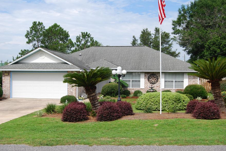 Beautifully Landscaped home on the South Side of Crestview. Home features 3 bedrooms and 2 full baths, Great Room with Cathedral Ceiling, Formal Dining Room, Kitchen with a Breakfast Nook, Split Bedrooms, Master Bath has double vanities, separate shower, a large walk in closet and tile floor, 2 additional bedrooms share a full bath and an inside utility room. There is Large covered and screened back porch overlooking lush backyard landscaping. There are 2 yard buildings for storage and a Covered Trellis for potting new plants. This home is a Showplace and won't last long.