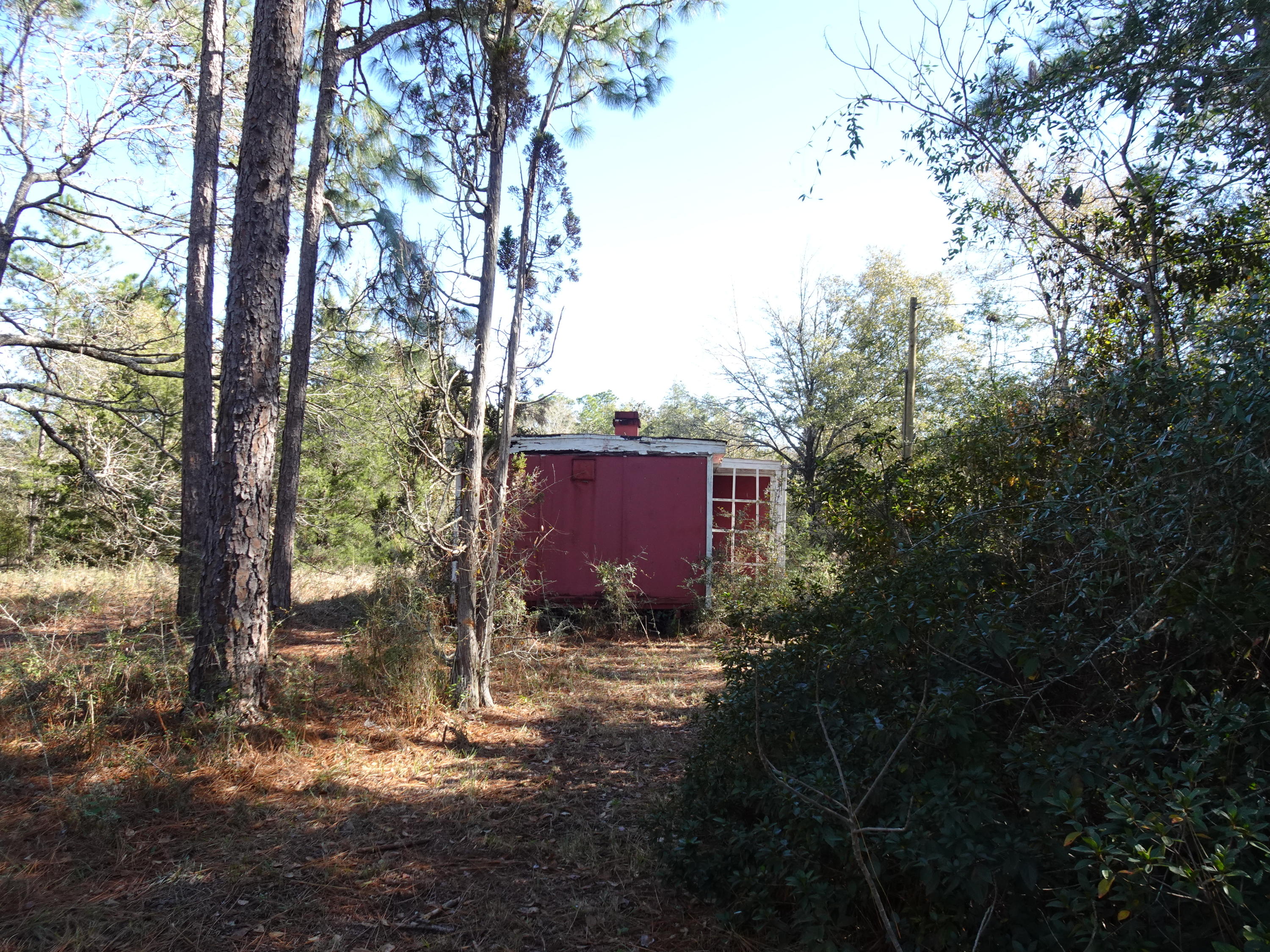 Corner lot on paved road. Remains of an old house (as-is) located on the lot. Electrical power pole is near the house. Appears an old well is also there. Condition is unknown. No knowledge if a septic is also there. Great location South of DeFuniak Springs for a new home or manufactured home.