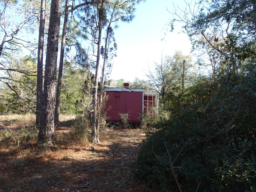 Corner lot on paved road. Remains of an old house (as-is) located on the lot. Electrical power pole is near the house. Appears an old well is also there. Condition is unknown. No knowledge  if a septic is also there. Great location South of DeFuniak Springs for a new home or manufactured home.
