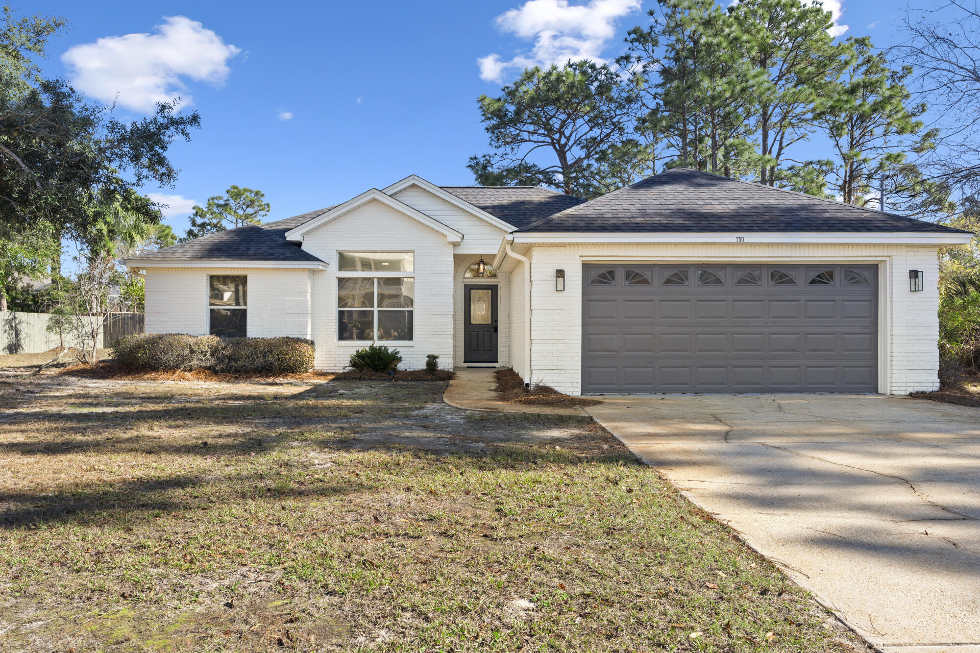 Welcome to your new home! Nestled in Santa Rosa Beach, this beautifully updated 3-bedroom, 2-bathroom home checks all the boxes! Located less than 10 minutes from the sugar-white sands of the Emerald Coast. This non-HOA property is a rare find in one of the area's most sought-after locations. Step inside to freshly painted interior that greets you with modern warmth, and raised ceilings, complemented by new LVP flooring, and new Roman Shades throughout. The spacious living area boasts a stunning fireplace -- perfect for those cozy evenings or gatherings with family and friends. The kitchen has been thoughtfully upgraded with brand-new appliances, painted cabinets, new hardware, and a pantry, offering a stylish and functional space to create your favorite meals, and/or for hosting parties. The home has also been recently updated throughout with new door hardware, and light fixtures. The home's exterior is has been painted, has a newer roof, and the best part of it all, the backyard overlooks a tranquil lake, which can be seen from the living room & dining room, perfect for fishing, kayaking or paddling boarding. Whether you're enjoying a morning coffee or unwinding after a day at the beach, this outdoor space is sure to become your personal oasis. You can also enjoy some s'mores by the fire pit. The garage was also recently painted, and has a brand new refrigerator/freezer that conveys with the home. The washer/dryer are also newer, and come with the home. Located just minutes from Grand Boulevard, you'll have easy access to top-tier restaurants, grocery stores, shopping, and entertainment. Nearby gorgeous beaches, State Parks, and Ascension Sacred Heart Hospital, you have all you need at your fingertips. With no HOA restrictions, you'll have the freedom to make this home truly your own. Don't miss this opportunity to enjoy the best of Santa Rosa Beach living in this beautifully refreshed home. Schedule your showing today! 