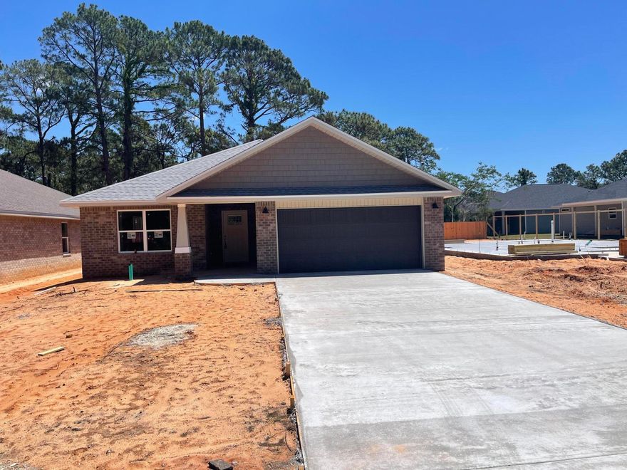 BRAND NEW 2023 ALL BRICK HOME NESTLED ON PEACEFUL END OF STREET LOT SURROUNDED BY OTHER NEW 2023 HOMES! Upon entry thru a deco top glass front door you are welcomed into a expansive living & dining space accented w/crown molding, recessed ceiling & tasteful lighting throughout.  The KITCHEN is located in a cozy front of home corner & is topped off w/huge Sunny window! It boasts LEVEL 3 Granite counters, Lg sink, Gray shaker style cabinets w/soft close drawers w/ ''coffee'' area counter cabinet, SS appliances - DW, Smooth cook top range & Built in Microwave, Long/Large eat up bar & Corner pantry. MASTER BATH - L3 Granite  counters, dual sink, Large shower w/glass door & wide sitting bench. Walk-in closet w/shelf nook. MASTER BR: Ceiling fan, puck LED lights, recessed ceiling w/crown. PLUS: Quality low maintenance wood plank Vinyl flooring in living areas. Stylish 12x24 tile in baths. Carpeted bedrooms. Double shelved Master closet. 2" Blinds on windows. Roomy covered back porch, Privacy fenced yard (42'+ deep) for a quaint place to relax in private & possible future pool, Large Laundry Room w/gray shaker cabinetry and a bonus nook area for future storage/shoe bench/cabinetry, etc... Hall Bath 2 has L3 Granite counter and tub/shower combo. ADDITIONAL FEATURES:
No HOA. Sprinkler System, Hurricane fabric shield, Quiet End of Street lot, One year builder warranty and more!
Located in close proximity to Hurlburt AFB, Beautiful Navarre Beaches, shopping, eateries and schools.
A NEW Home Ready Estimated Beginning of June 2023 for a First Owner!!
Wont last long! Call today to see!