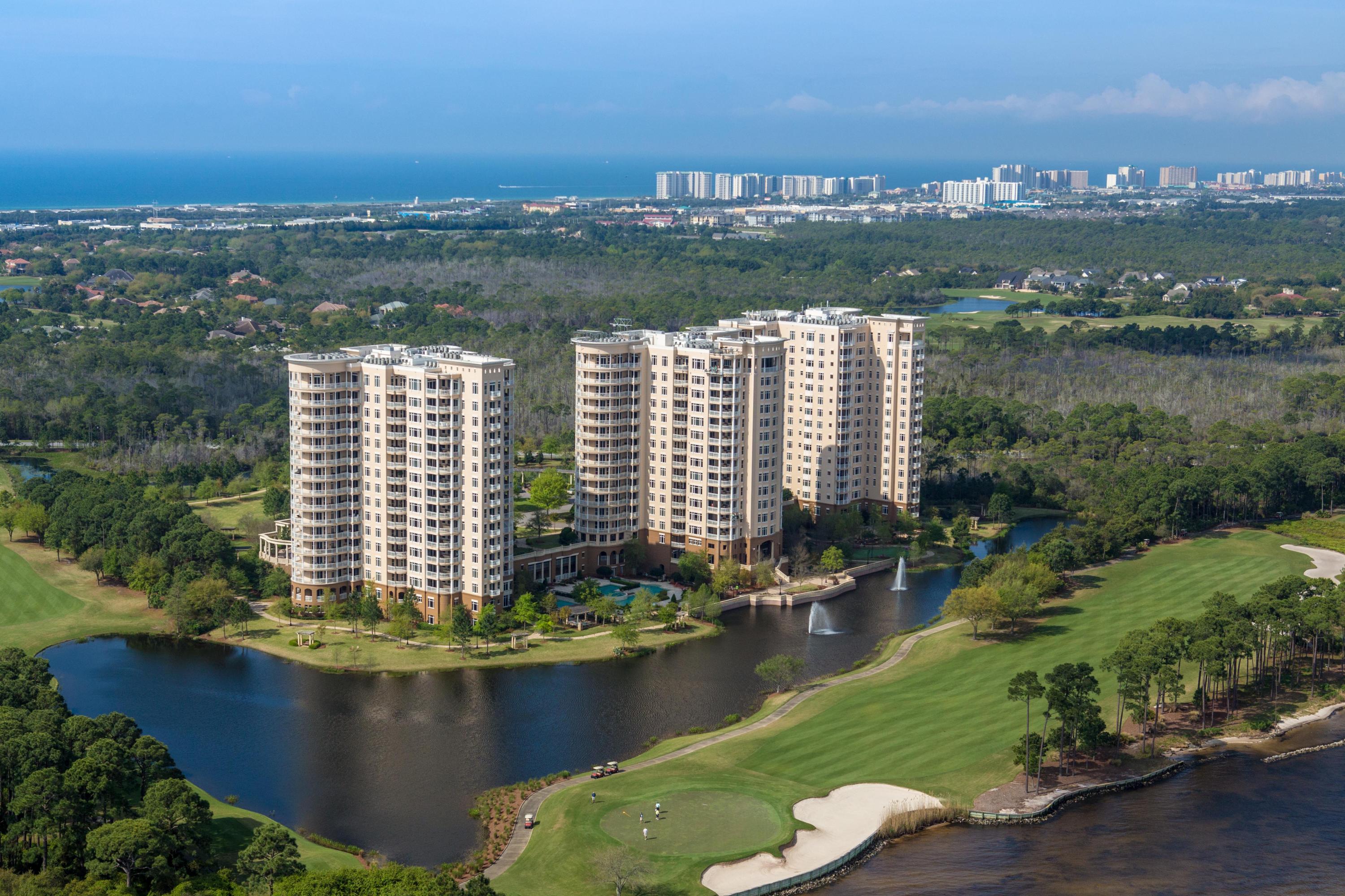 Luxury in the sky! Savor a stunning bird's eye view of the beauty of the Emerald Coast from this gorgeous One Water Place penthouse. Its desirable Castleton floorplan, featuring 3 bedrooms plus a large home office and wrap-around balcony, is enhanced by the 12' ceilings and greater privacy afforded by its top-floor location. The residence is excellently situated to enjoy views of the Gulf of Mexico, Choctawhatchee Bay, Fred Couples Signature Golf Course, and the abundant natural preserve land in Kelly Plantation.As befits the amazing natural setting, the interior exhibits artistic flair and grandeur, combined with attention to quality and convenience. The floors are 18x18'' Turkish Marfil polished marble. Custom carved marble fireplaces provide a focal point in the living room and...