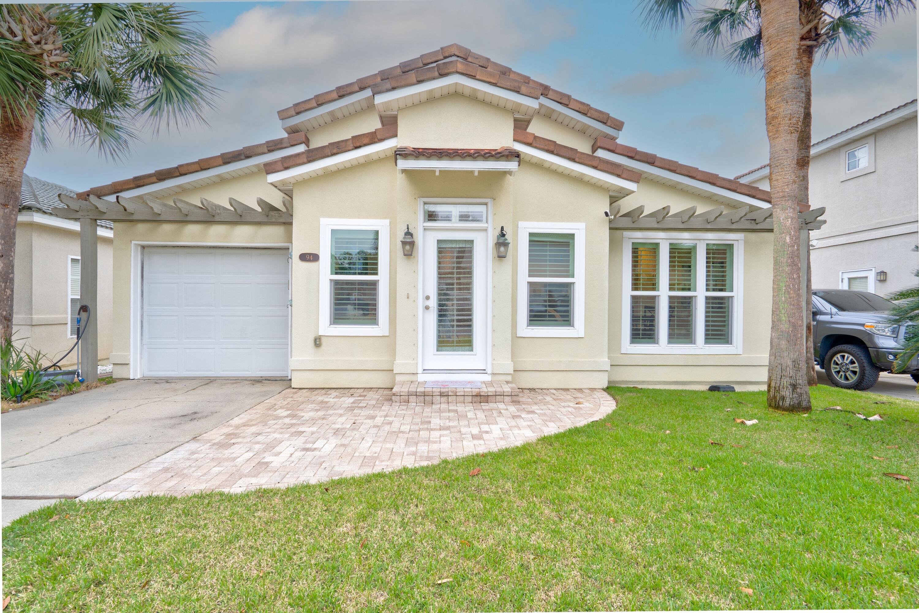 Open concept Mediterranean cottage, gated community, south of 98! Rental restricted community. Close to shopping, dining & gulf, but when you want to come home to peace and quiet this is it. Owner has done many updates. These include paid for solar panels May 2020. all new windows Aug. 2022 (with exception of garage window and transom above front door. Windows in the front of home and front and back doors are hurricane impact. New flooring June 2019. Major kitchen remodel with KitchenAid gas stove, Bosch dishwasher, Whirlpool refrigerator, new cabinets, granite countertops. New bathroom cabinets, quartz countertops. Attic insulation replaced July 2023. Termite prevention system installed June 2021. Plantation shutters in front living area. A/C & compressor: 2018.