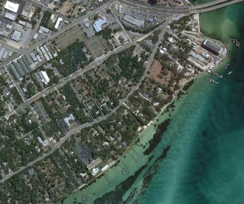 Developers dream location! This .99+- lot features zoning for 11 units and also an all brick home build by hand by the owners family! Perfect for a townhouse development in the heart of Destin! Buy this lot get a free home with the purchase! Don't miss out on this prime mixed use property that is walking distance to the harbor, restaurants, and much more! Measurements and square footage are approximate and should be verified by buyer.