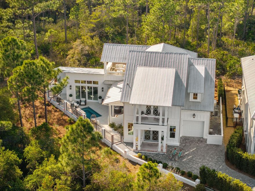 Surrounded by towering pines, against the peaceful backdrop of the state preserved Forest, this custom-built 3,400 sq ft residence offers privacy, luxury, and refined coastal living. Situated on a premium southern-exposure lot in a gated, non-short-term rental community just 1.4 miles from 30A's beaches, this 5-bedroom, 4 full bath home with an additional powder room is designed for comfort and entertaining.The first-floor primary suite features a private sitting room, while a separate cabana with full bath and fireplace overlooks the heated pool and outdoor living area. Inside, enjoy Wolf and Sub-Zero appliances, two gas fireplaces, first and second floor laundry, whole-house generator, UV light air purification system, and infrared sauna. Surrounded by nature yet close to everything, this exceptional property offers rare seclusion with high-end amenities throughout.

