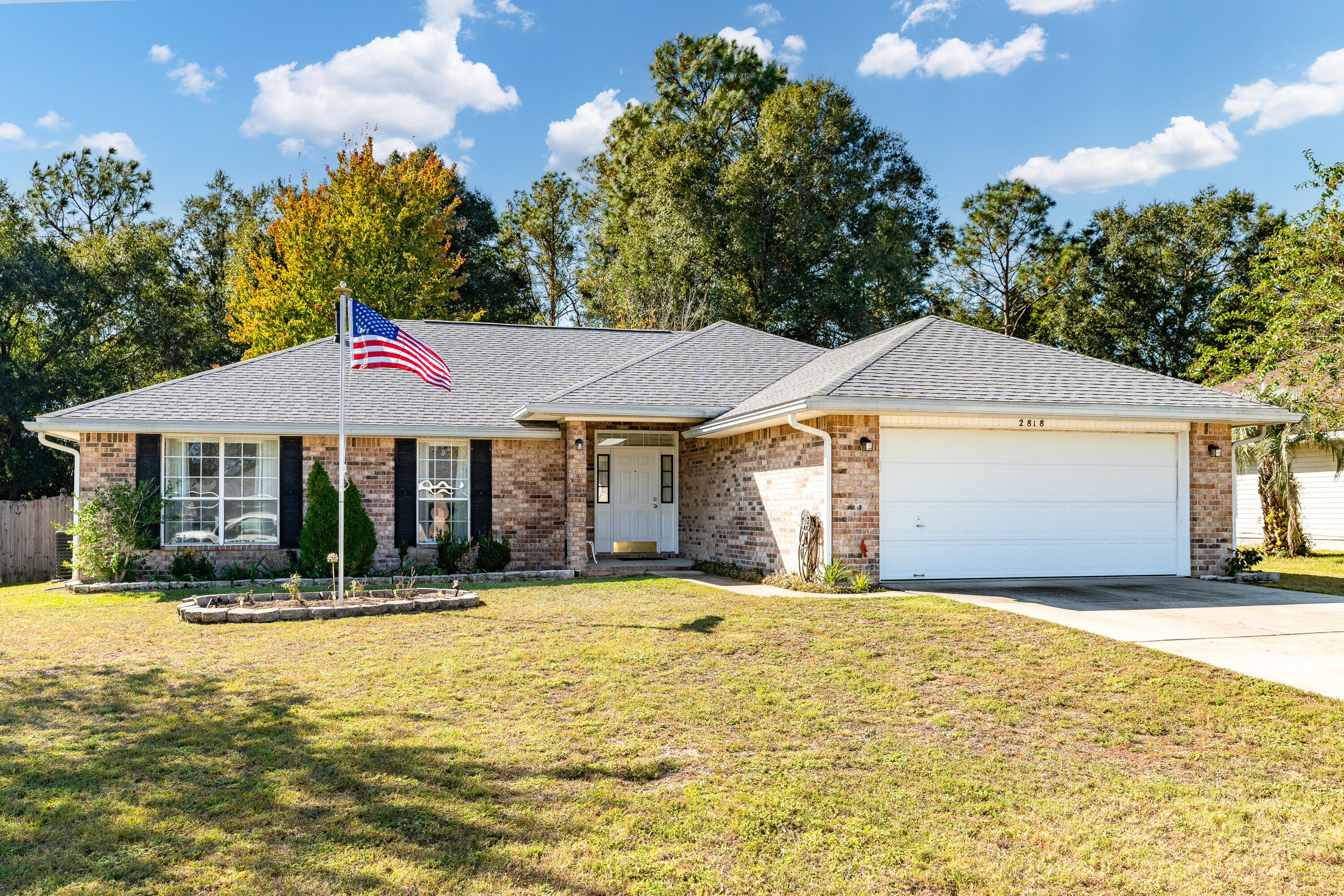 Welcome to 2818 Atoka Trail!  Come inside this well-designed home located just south of I-10.  This location is perfect for a quick commute to local bases and beaches.  Step inside to discover vaulted ceilings and large windows that enhances the open feel, seamlessly connecting the living room, dining area and kitchen. A versatile 4th bedroom or study is conveniently located off the foyer, perfect for guests or a home office.You will find plenty of counterspace in the well-appointed kitchen complete with a gas range, making it a dream for the home chef!  The split floor plan enhances privacy. Retreat to the master suite complete with a large double vanity, walk-in closet and linen closet in the spacious master bath.The remaining two bedrooms are ample in size with convenient  access to the tastefully updated full bath.
Enjoy your mornings or unwind in the evenings on the screened in porch, overlooking a large, flat backyard that offers plenty of room for outdoor activities.  With protected wooded green space directly behind the home, you will appreciate the added privacy. And bonus...this home also comes with its own security system.  Don't miss this opportunity to make this property your home...Make an offer today!
