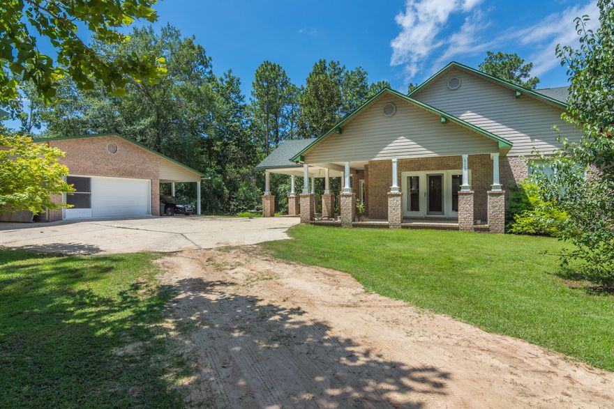 Welcome home to your beautiful private oasis! This well manicured 2.15 acre home is nestled in persimmon trees a creek and even a garden for you to enjoy! Features 3 covered carport spaces with a 2 car detached garage with movable screens, workbench, fridge, and stairs to loft storage. Fenced portion for your pets, creek access with hammocks and a fire pit and screened back porch to over look the gorgeous landscape and country setting. Home is 3bd/2a with 2 eat in areas. Hardwood and tile throughout. Kitchen has gas cooktop on island and convection oven. Open floorpan that looks over the living room. Master suite, bath has garden tub and separate shower, dual vanities with plenty of cabinet storage. Rinnai tankless water heater.