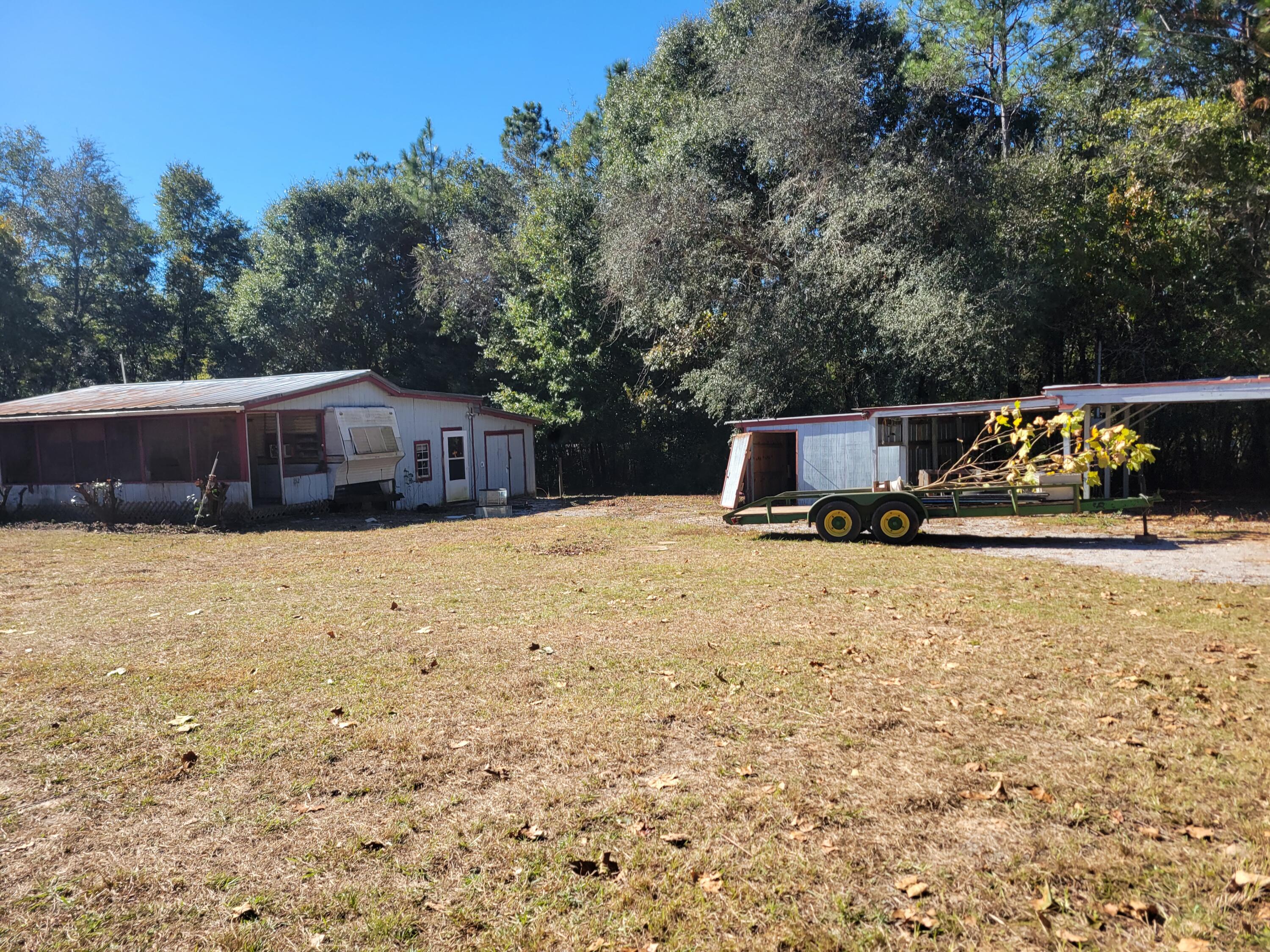 Wooded lot with a septic tank.  Just off Hwy 90 W and Kings Lake.  Dimensions are subject to an up-to-date survey.  Removal of structures will be  Buyer's responsibility. (not livable), no value given.   You will need a city water tap or well and a new power pole.  Septic tank not guaranteed.