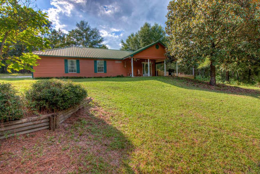 The best of country living on the outskirts of town! Check out this beautiful country style home with deep ''sitting'' porch and 2.65 acres of privacy. This quaint property features 3 bedrooms and two full baths with an open concept living room, kitchen and dining area. The master bedroom suite is generously sized to fit a king sized bed along with your dressers and side tables and the master bath features a soaking tub and separate shower, double vanity and separate water closet. The laundry room doubles as a mud-room and accesses the back of the property and the hot tub. The grounds are ready for livestock and have outbuildings for a chicken coup, a rabbit cage and a large shed/barn (all convey in as-is condition). Get away from town in your own country oasis today!