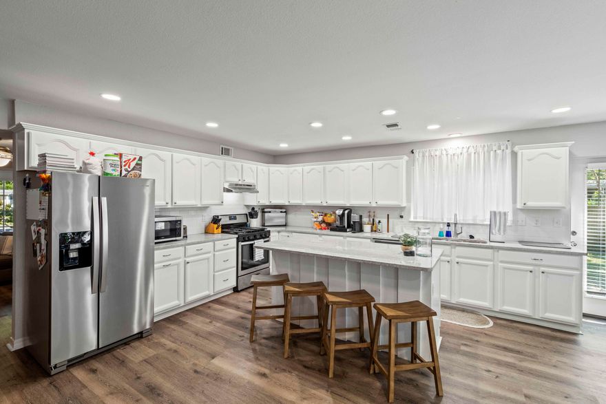 Discover the perfect blend of modern comfort and natural beauty in this 4-bedroom, 2-bath home, ideally positioned with Ferry Park right over your back fence--an absolute haven for nature lovers and outdoor enthusiasts! Step inside to find a spacious, beautifully updated kitchen that truly steals the show. Granite countertops, a chic tile backsplash, and gleaming stainless steel appliances create a contemporary yet welcoming vibe. The oversized island, adorned with eye-catching board-and-batten detailing, is not only a centerpiece but also a functional gathering spot for family and friends. Enjoy the seamless connection to the living area, where a cozy fireplace echoes the island's craftsmanship, adding warmth and charm to the space. The heated and cooled one-car garage offers endless versatility, whether you need extra storage, a workshop, or additional living space. Nearby, you'll find a thoughtfully designed laundry room featuring a full-sized Samsung Champagne stackable washer and dryer - both included for your convenience.

The home also features a spacious screened front porch, perfect for enjoying morning coffee or relaxing in the evening breeze. In addition new roof decking was installed under the metal roof in 2022.

Nestled in a serene location with direct access to Ferry Park's trails and open spaces, this home is more than just a place to live - it's a lifestyle. Don't miss your chance to call this extraordinary property your own!
