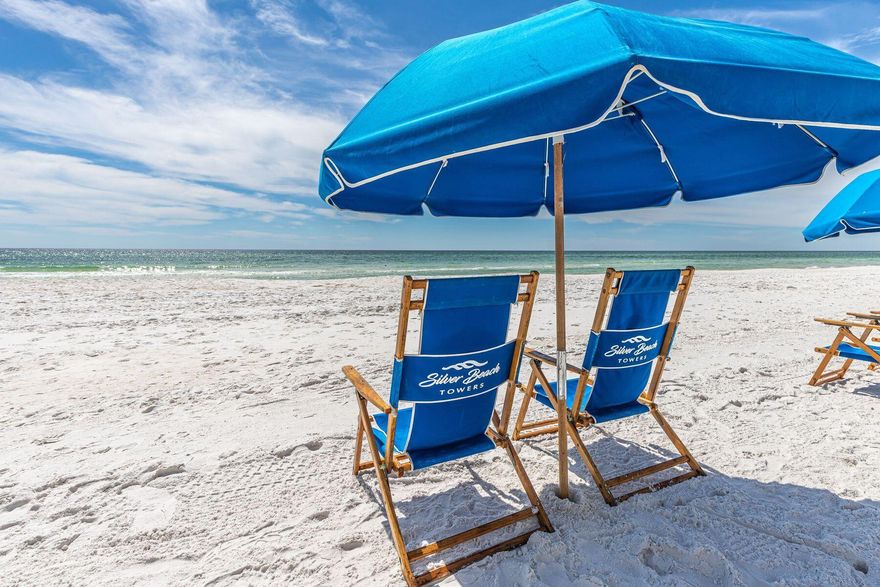 Complete Remodel...it's all been done! Plus + Beachside food and beverage service now at Silver Beach Towers! Who wouldn't want yummy food and tasty frozen drinks delivered right to their beach chair? Offering panoramic views, this completely remodeled larger 3 bedroom gulf-front condo has a popular split floor plan. It is beautifully presented with all-new lighting, custom window treatments and graceful furniture included in the sale. New engineered wood flooring flows throughout the unit, giving way to new tile floors in all three bathrooms. The entrance hall welcomes with tasteful board and batten finishes. This leads to two large guest bedrooms, both with generous private bathrooms and access to a private balcony. The hub of the home is the bright open living room, featuring plentiful windows and sliding doors onto the main balcony. Serve drinks from the beverage refrigerator at the custom bar before putting your feet up in this comfortable living space. Dine and entertain in the dedicated dining area where serene gulf views provide a relaxed ambiance. The chef's kitchen has loads of storage and a full range of stainless appliances including a new stove and a modern French-door refrigerator. Granite counters extend across the bar where four diners can enjoy a hearty breakfast before heading out for the day. The separate laundry takes care of beach towels, keeping everything neatly out of sight. The spacious master bedroom delivers breathtaking views through sliding glass doors leading onto the balcony. Enjoy gentle gulf breezes as you gaze at the stars before falling asleep each night. A sliding barn door hides the master bathroom with its sumptuous jetted tub, new tile floors and waterfall countertops on the twin vanity. The third-floor location makes everything easily accessible and provides elevated views of the pool, beach and stunning Gulf of Mexico. Imagine sipping cool drinks on the spacious terrace while enjoying expansive sunset views each evening. Silver Beach Towers has excellent amenities including on-site food and beverage offerings, elevators, covered garage parking, exterior owner's storage cages, tennis courts and multiple pools. Direct access to the private beach ensures the perfect vacation for owners, guests and renters.