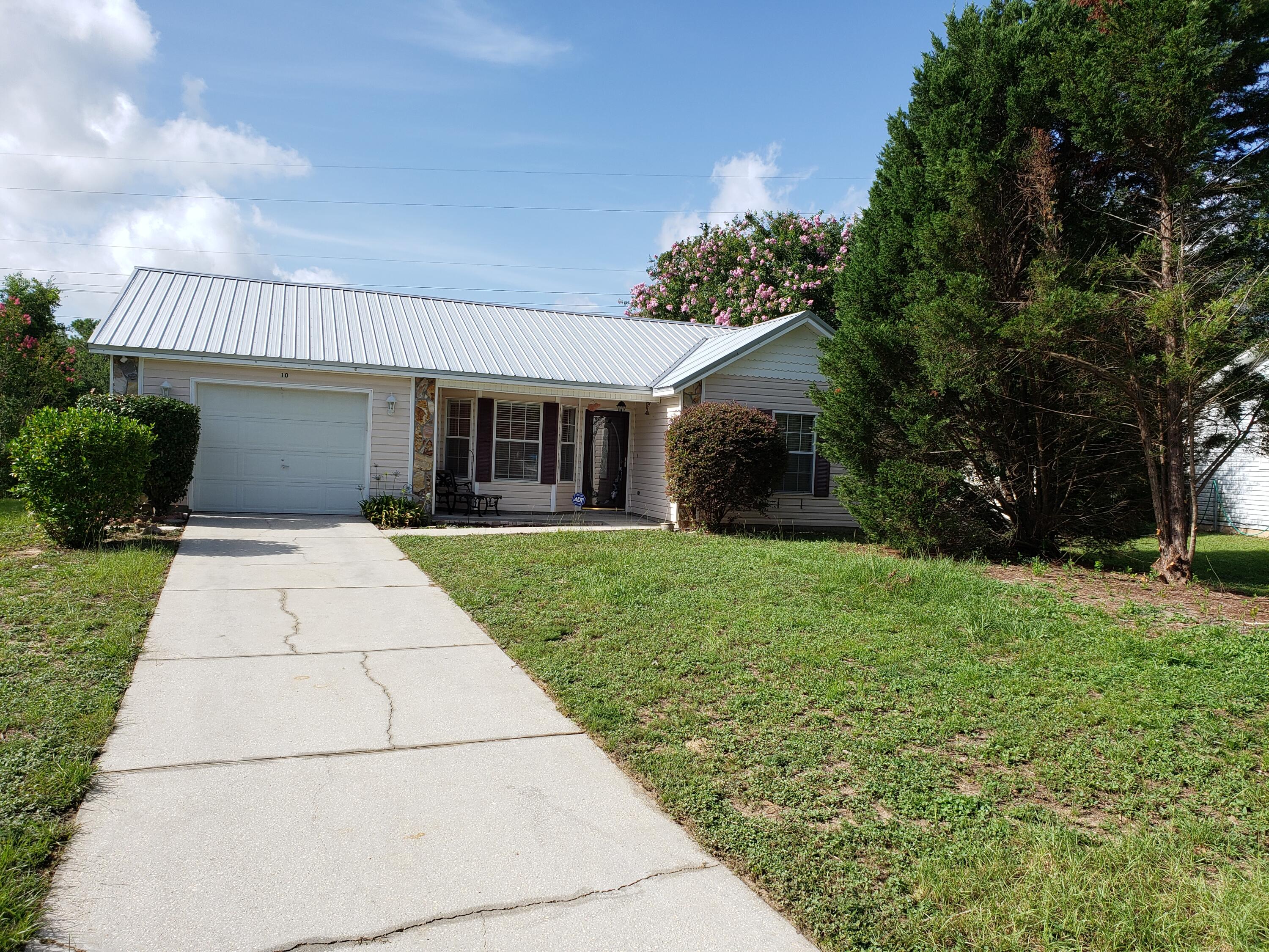This 3 bedroom, 2 bath, 1 car garage home is centrally located and ready for you! The living room area has high ceilings and wood laminate flooring. The kitchen has a breakfast bar and fridge, stove/oven, microwave, and dishwasher. The bedrooms are a split bedroom floor plan and all have new carpet. Outside boasts a screen porch, storage shed, and a very large backyard space. One car garage for storage needs and lots of driveway parking as well. Come by and check out this property for rent!
