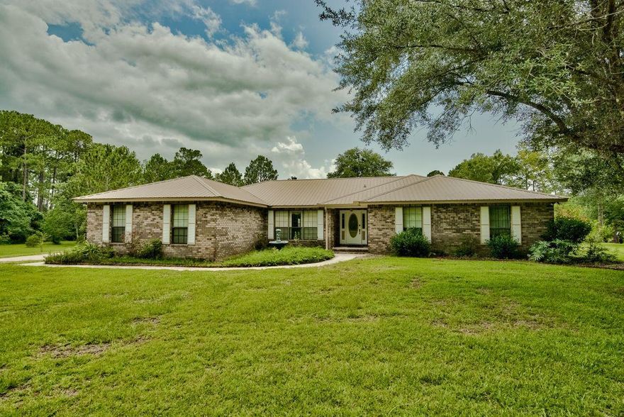 Beautiful ranch style brick home sitting on an incredible 2 acres of land in Crestview. This three bedroom, three bathroom home has a beautiful view of Clyde Reese Lake with 300+ ft of water frontage and a dock. New upgrades within the past few years include: new metal roof, granite countertops and kitchen appliances. Formal living room could be used as additional bedroom, media room, or office space; the potential is endless! Enjoy the lake views at the ideal breakfast nook and your evening meals in the formal dining room. Ideal home for a buyer looking for land, views and an easy commute to Eglin AFB, Duke Field or the beautiful beaches of Destin, FL. A whole house generator was installed in April of 2016. A water heater was installed at same time as well as a gas vent free gas logs.