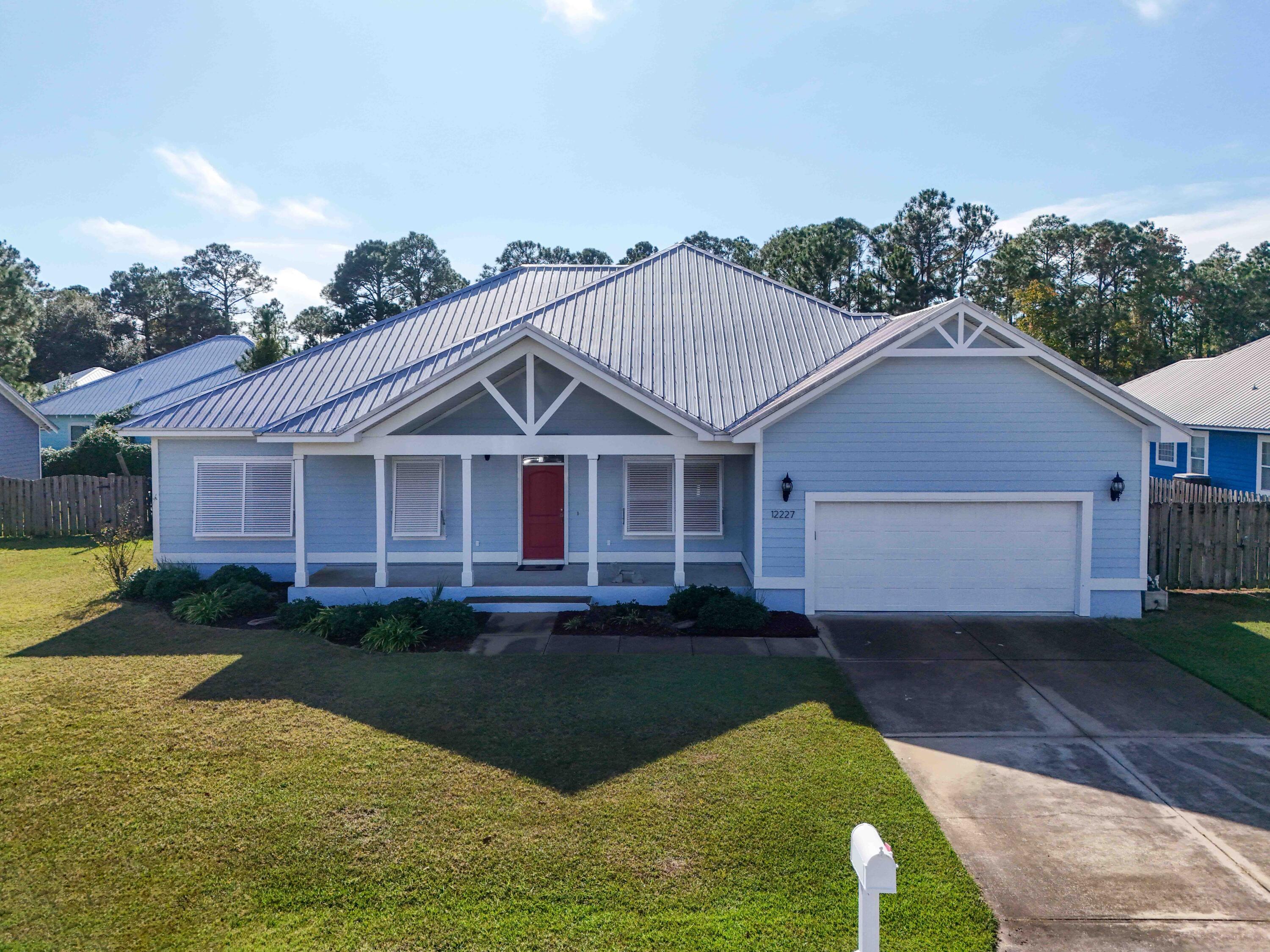 Welcome to your stunning new home in the sought-after Lyndell Plantation community! This gorgeous residence is situated on a spacious .3 acre lot, complete with covered front and back porches that invite you to relax and enjoy the tranquil surroundings. The privacy fenced backyard offers both security and serenity, featuring a convenient shed for all your storage needs. The exterior is highlighted by a durable metal roof, Bahama Shutters (reduce insurance cost) and a well-appointed 2-car garage, along with a large driveway providing ample parking for family and guests. Inside, 2 Master Bedrooms! One Master Suite has a private entrance. Discover elegant wood floors, Plantation shutters and tile throughout the main living areas. Ceiling fans in every room. The kitchen is a chef's delight The kitchen is a chef's delight, equipped with stainless steel appliances, a natural gas range, and an island with bar seating that opens to the dining and family room, creating an ideal space for entertaining. This home boasts impressive 12-foot ceilings and features four generously sized bedrooms and three full bathrooms. The exquisite primary suite is a true retreat, featuring a spacious walk-in closet and a luxurious master bath complete with a double vanity, separate shower, and soaking tub. Positioned conveniently south of PCB Parkway, this property allows for easy golf cart access to the beach or a short walk, where you can bask in the beauty of emerald green waters and sugar-white sands. Enjoy being just 3.5 miles from Pier Park, and minutes away from Publix, Home Depot, schools, and an array of restaurants and attractions. For both recreational enthusiasts and beach lovers, you're also minutes from top-rated golf courses and the scenic 30A. This move-in-ready home checks all the boxes with its spotless, meticulously maintained interiors, built by Bohn Construction. A survey is available, and a termite bond is in place, providing additional peace of mind. Don't miss this incredible opportunity to call this coastal paradise your own!