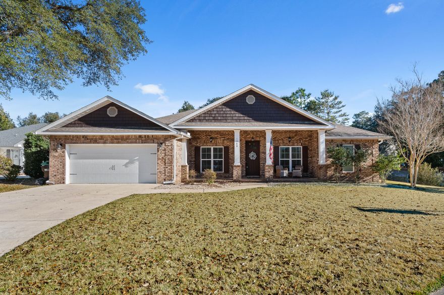 Wake up to stunning lake views and start your day with coffee on the expansive 42' x 10' covered back porch. In the evenings, retreat to your private backyard oasis featuring a beautifully paved patio and firepit, perfect for cozy nights, entertaining guests, and soaking in peaceful waterfront sunsets. Tucked within a charming, small neighborhood in highly sought after Bluewater Bay, this exceptional home blends comfort, elegance, and a relaxed coastal lifestyle. The open, light-filled floor plan features four generously sized bedrooms with plenty of space for guests and entertaining. Designer finishes shine throughout, including wood-plank tile flooring, soaring ceilings up to 12', elegant trey ceilings, and crown molding that adds timeless character The spacious living room with a double trey ceiling and gas fireplace creates the perfect gathering space to relax, read, or host friends. The sleek, gourmet kitchen is both beautiful and functional, showcasing all-wood cabinetry with soft-close drawers, granite countertops, a large island with storage and hop-up bar, and slate finish appliances including a gas range and stainless refrigerator. This exceptional home offers the perfect balance of luxury, comfort, and lifestyle in one of Bluewater Bay's most sought-after locations.