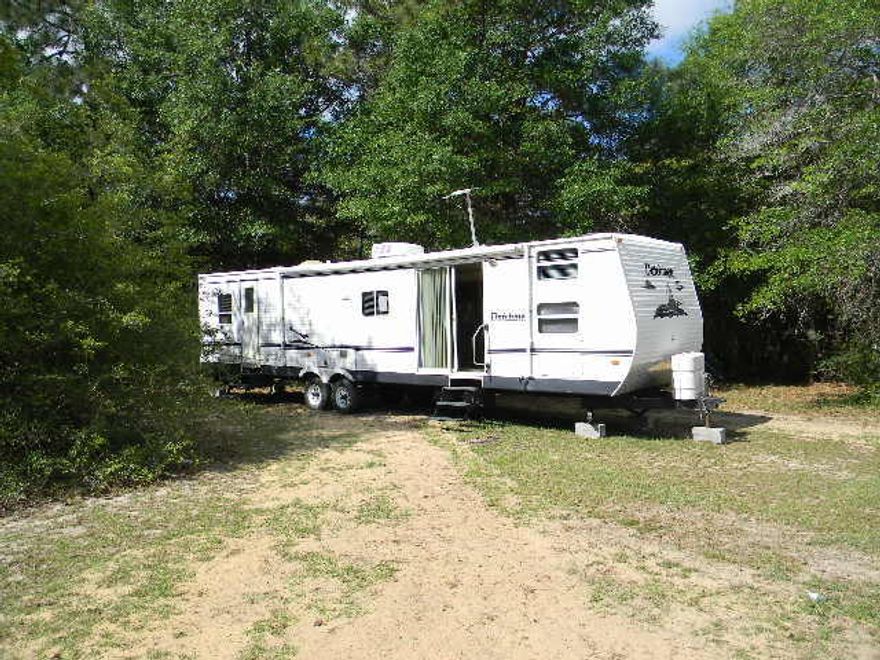 Country living north of Crestview. Quiet location with lots of trees. Small 1 bedroom, 1 bath motor home sits on a large lot with 2 other homes. Water and electric are included in the rent. A small pet is allowed for an extra $25.00 per month. Call to schedule your appointment today.