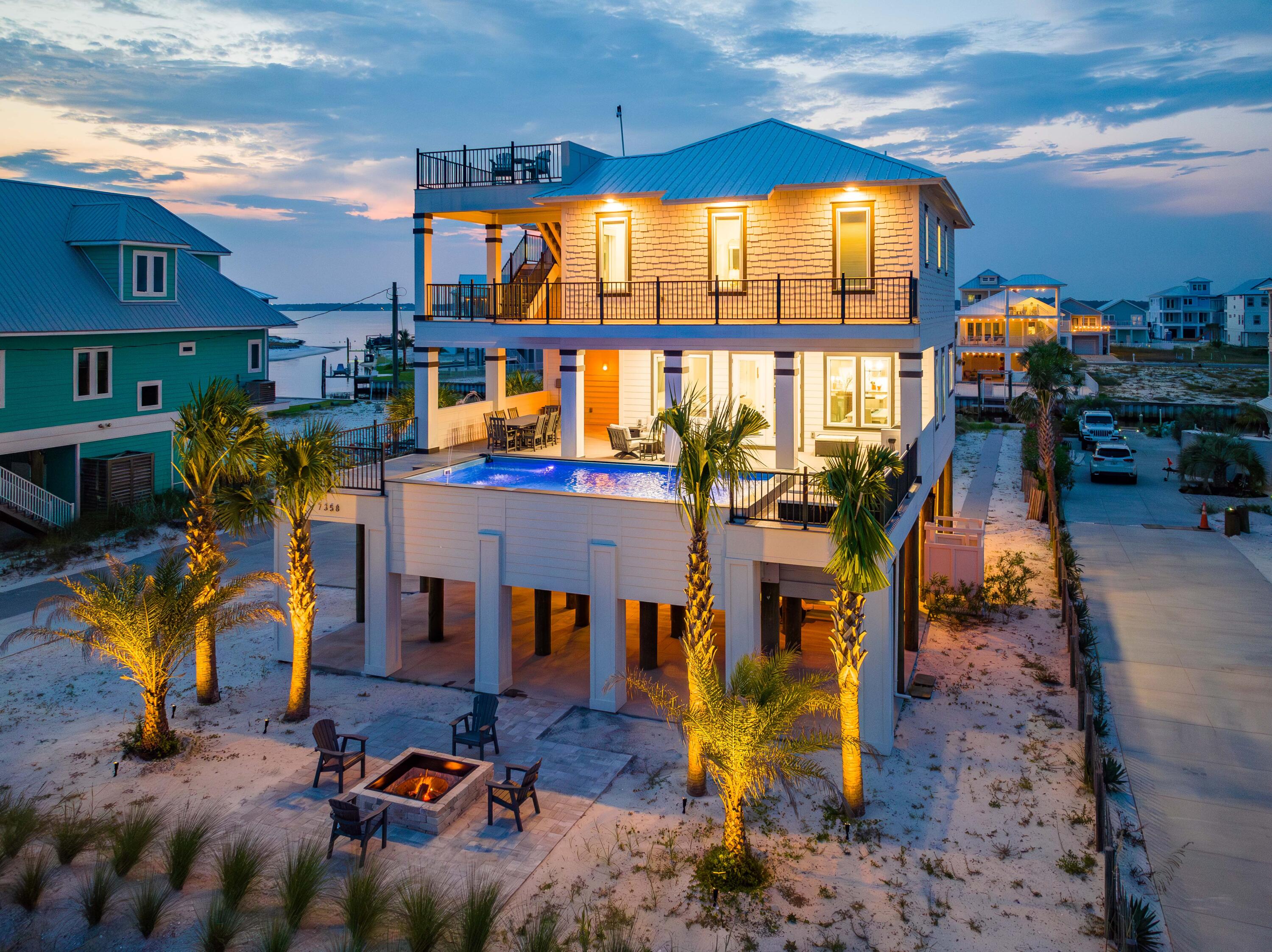 Unparalleled 2022 Construction highlighting a Raised Pool, 20ft Canal Easement, Gulf and Sound Views! Nestled between the azure waters of the Gulf of Mexico and Santa Rosa Sound, this lavish 4 bed + Bunk, 3.5 bath coastal retreat blends modern elegance with seamless convenience providing an unmatched Living and Entertaining experience for owners and guests.A Rare Exceptional find, this property brings the water to you with a 20ft canal easement, allowing direct access to the Sound, making the possibilities for water adventures endless. The Raised Pool resides a part of the home's 2000+ sqft of balcony space. A Standout feature located just outside of the 2nd FL living area, the Raised Pool offers ease at your fingertips with its App-Controlled Light, Jet, and Fountain features. Built by JMJ Construction and Professionally Decorated, the interior boasts meticulous craftsmanship with high-end finishes and attention to detail evident throughout. Its open-concept design features 10ft ceilings all throughout, filling the space with natural light and offering mesmerizing views of the Gulf. Maximizing the communal space on the 2nd floor, you'll find all 4 bedrooms + Hall Bunks located on the 3rd Floor. In keeping with convenience, an elevator services all 3 floors of the home.
For those seeking the ultimate vantage point to soak in the surrounding beauty, an observation deck with a 360-degree view awaits at the property's highest point. From this elevated perch, you can witness the special shower of fireworks on the 4th of July or everyday magnificent sunrises and sunsets.
This property has never been rented, ensuring its pristine condition and the preservation of its unique character.
With its impeccable design, outstanding amenities, and prime location, 7358 Gulf Blvd represents an extraordinary opportunity to own a one-of-a-kind coastal retreat that will undoubtedly become your slice of paradise. Don't miss your chance to experience the best of Gulf Coast living.