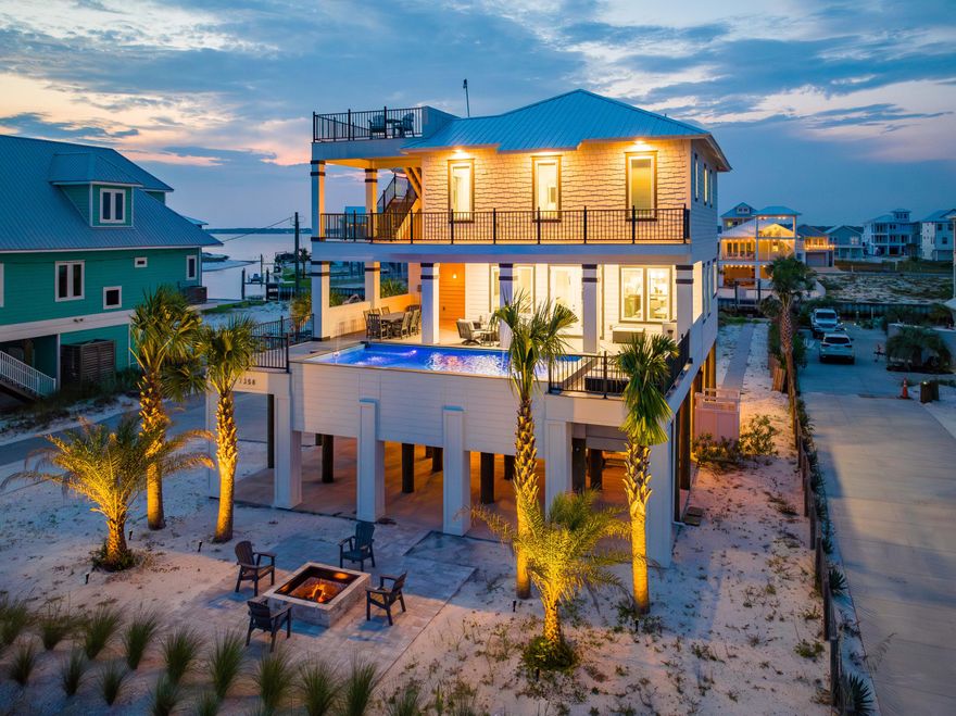 Unparalleled 2022 Construction highlighting a Raised Pool, 20ft Canal Easement, Gulf and Sound Views! Nestled between the azure waters of the Gulf of Mexico and Santa Rosa Sound, this lavish 4 bed + Bunk, 3.5 bath coastal retreat blends modern elegance with seamless convenience providing an unmatched Living and Entertaining experience for owners and guests.A Rare Exceptional find, this property brings the water to you with a 20ft canal easement, allowing direct access to the Sound, making the possibilities for water adventures endless. The Raised Pool resides a part of the home's 2000+ sqft of balcony space. A Standout feature located just outside of the 2nd FL living area, the Raised Pool offers ease at your fingertips with its App-Controlled Light, Jet, and Fountain features. Built by JMJ Construction and Professionally Decorated, the interior boasts meticulous craftsmanship with high-end finishes and attention to detail evident throughout. Its open-concept design features 10ft ceilings all throughout, filling the space with natural light and offering mesmerizing views of the Gulf. Maximizing the communal space on the 2nd floor, you'll find all 4 bedrooms + Hall Bunks located on the 3rd Floor. In keeping with convenience, an elevator services all 3 floors of the home. 

For those seeking the ultimate vantage point to soak in the surrounding beauty, an observation deck with a 360-degree view awaits at the property's highest point. From this elevated perch, you can witness the special shower of fireworks on the 4th of July or everyday magnificent sunrises and sunsets.

This property has never been rented, ensuring its pristine condition and the preservation of its unique character.

With its impeccable design, outstanding amenities, and prime location, 7358 Gulf Blvd represents an extraordinary opportunity to own a one-of-a-kind coastal retreat that will undoubtedly become your slice of paradise. Don't miss your chance to experience the best of Gulf Coast living.