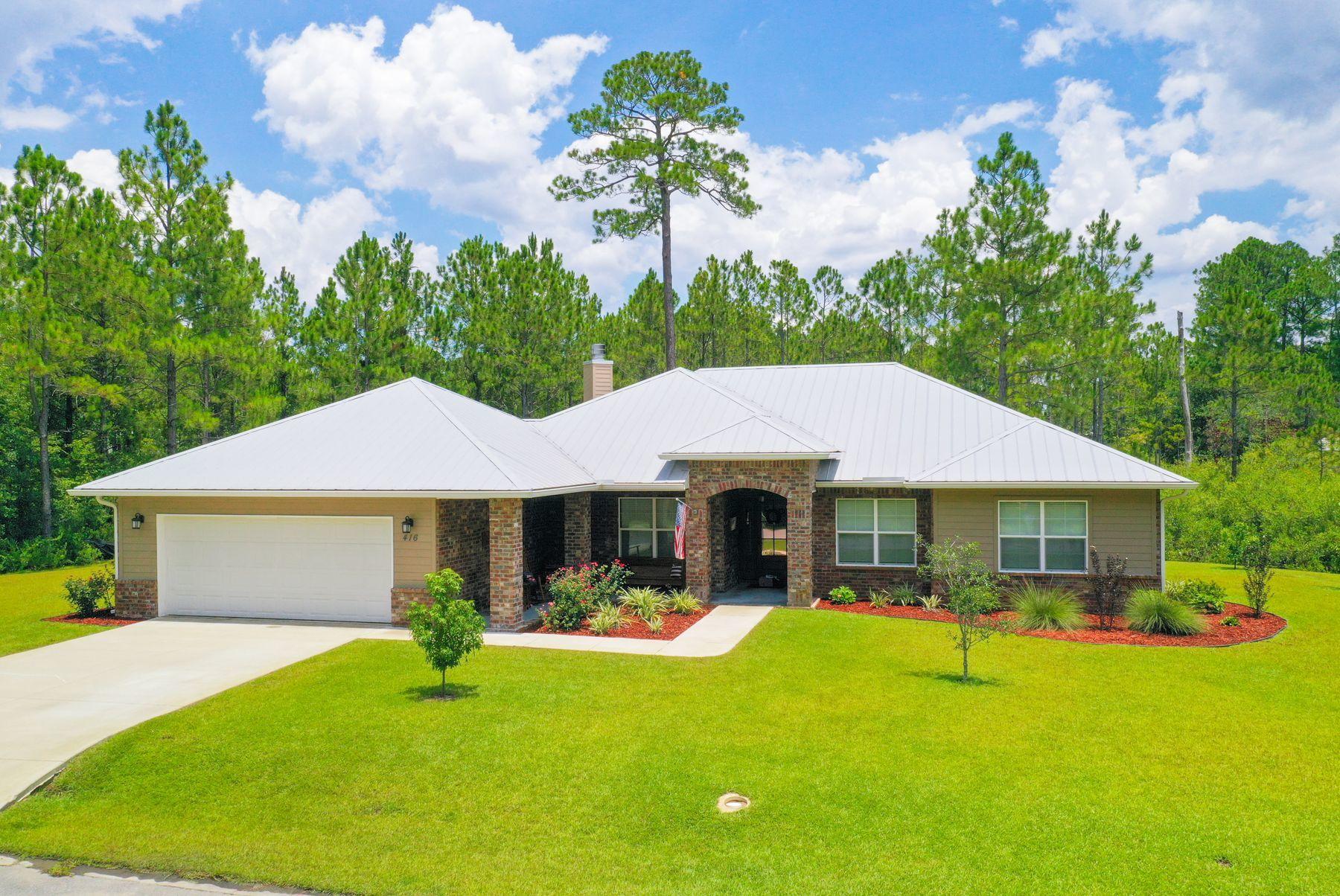 Less than a minute to Choctawatchee Bay and just a few minutes to the beach and shopping, this house in Seclusion Bay is ideally situated for privacy and a quiet lifestyle in a quality home. Not yet three years old, the single-floor living ranch features an open floor plan with a charming kitchen. The corner sink is nestled into the ell created by the breakfast bar and the counter, with natural daylight through a nice window over the counter. Gleaming stainless steel appliances and granite counters are complemented with cottage cabinets in deep sage and rich pewter tones.A stacked stone corner fireplace adds another angle of interest. Three bedrooms and two full bathrooms offer a nice configuration for family life, young professionals or retirement. Beyond the front porch and large back deck, the more than half-acre property is beautifully manicured with a lush lawn, shrubs and tall trees in back. High quality construction includes 2x6 exterior walls, foam insulation even between interior walls, plus the low maintenance brick and siding exterior and metal roof. Surround sound permeates the family room, and a barn wood mantle and mahogany front door provide beautiful natural touches. Seclusion Bay is gated and secluded with just over four dozen lots and 15 acres of preservation land. The curb appeal factor is grand, and the neighborhood is very inviting.