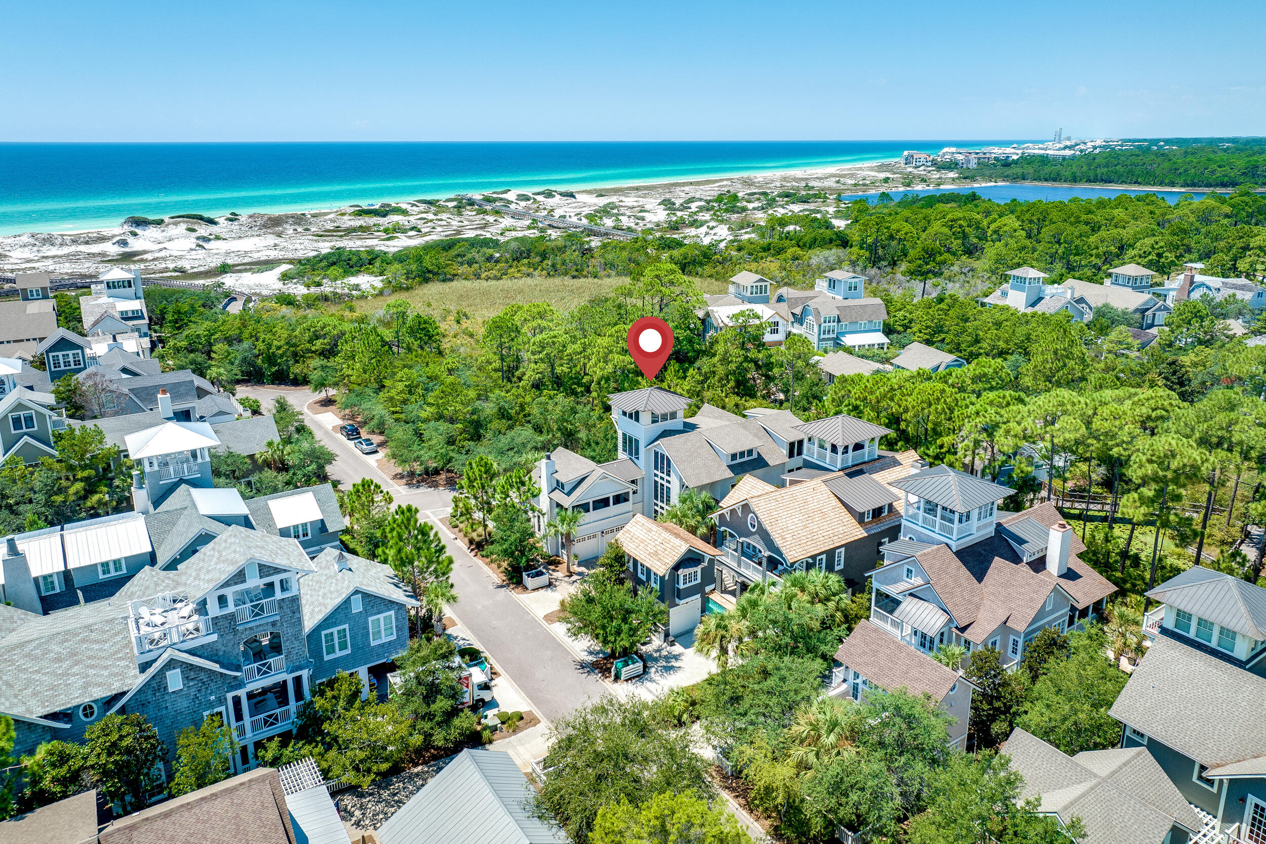 Introducing a captivating residence nestled on a corner lot mere moments from the beach & golf path. This estate boasts a safeguarded conservation area to its south, maximizing privacy & curtailing future development. It features one of Watersound's largest pools --a saltwater oasis, with hot tub, tanning shelf & privacy fence. Outdoor living space is accompanied by a gas firepit. The lush landscaping lends an aura of seclusion. The kitchen boasts superior first-class appliances, & an airy, luminous walk-in pantry serves as storage & bar room. The adjoining dining area seamlessly transitions into the inviting living space, anchored by a gas fireplace. Off the great room lies the screened porch, an idyllic spot for relaxation. A primary suite awaits on the ground floor, complete with an en-