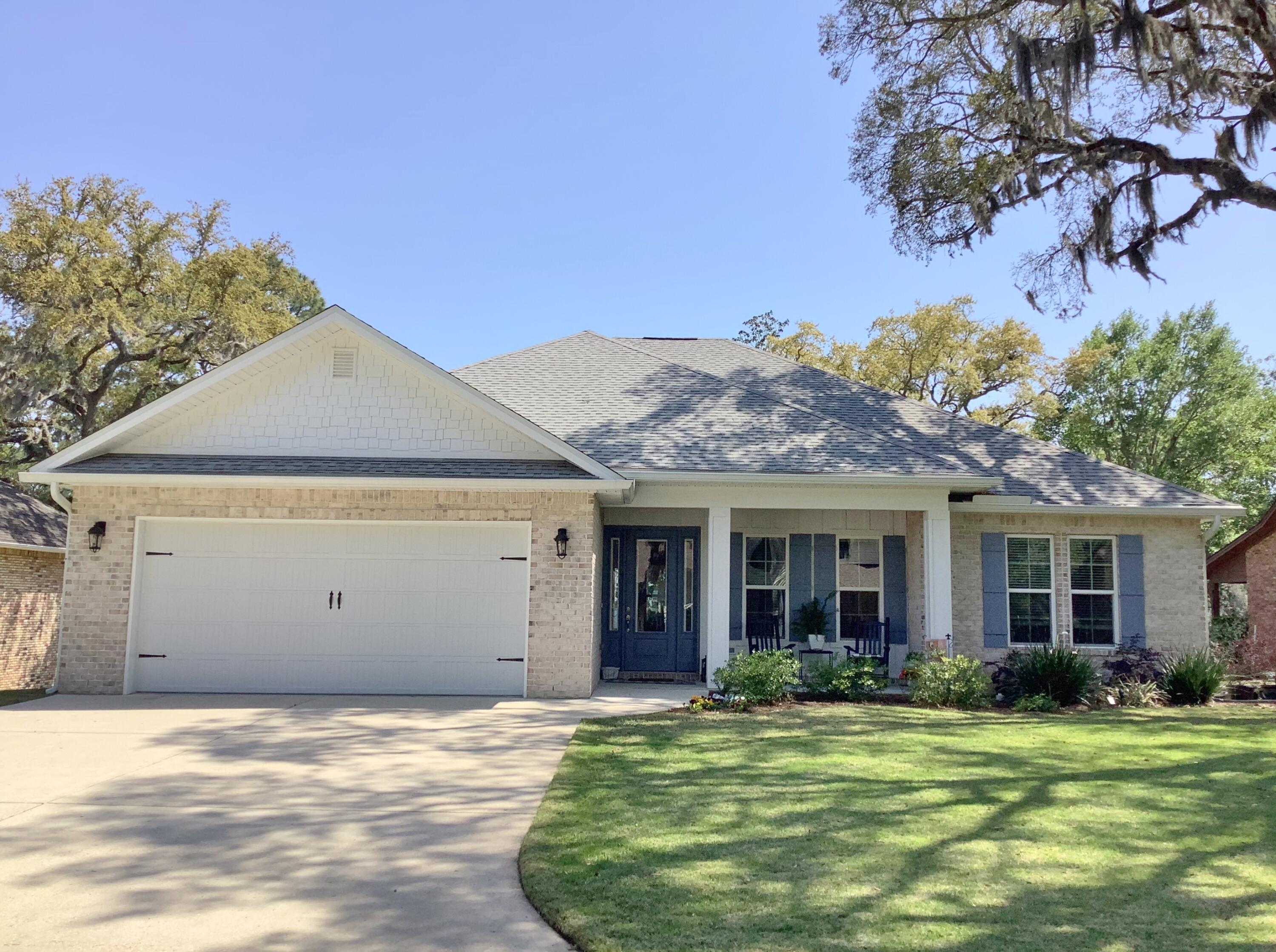 We proudly present this WATERFRONT, all brick, Coastal inspired home tucked securely away on aa cul-de-sac optimally located on secluded Hands Cove Bayou offering breathtaking sunsets, endless views, a 12x12 boat dock with 4 ton boatlift and easy access to the Bay and all types of water based activities only life on the water can offer. Starting with the front porch, the tongue and grooved cypress ceiling lets you know you're in for a real treat. Upon entering the impressive foyer, you'll be greeted with stunning views and the careful attention to detail with 10' ceilings, 8' doors, and engineered birch hard wood floors throughout the living areas. This bright, open concept floor plan features a Chef inspired kitchen with custom wood cabinetry, soft close drawers and cabinets,