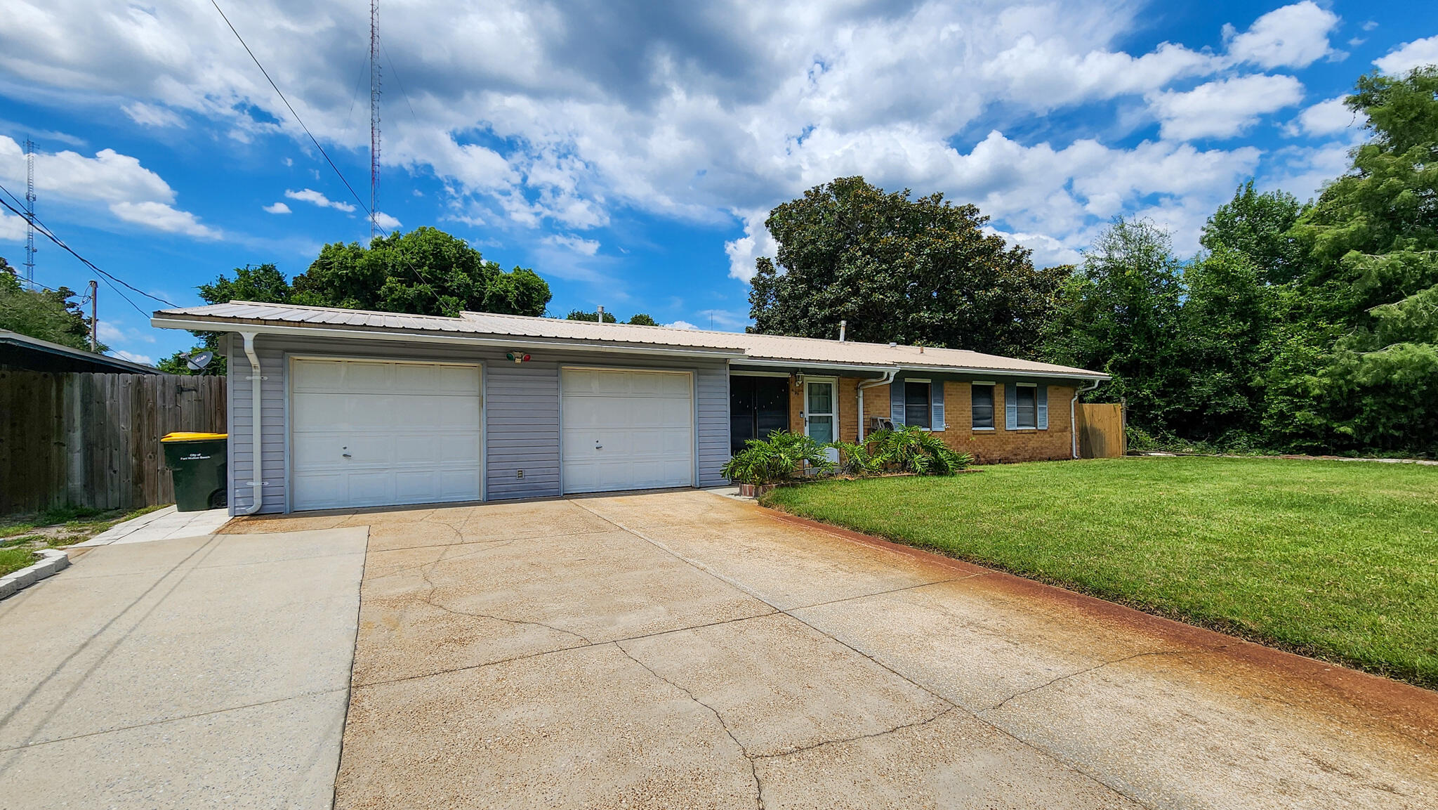 Welcome to this inviting 4-bedroom, 2-bath home nestled on a quarter-acre lot! Step into the comfortable living room that flows seamlessly into the dining area and kitchen. Just off the dining area, you'll find a generously sized laundry room and access to a bright den featuring large windows, a built-in bookshelf, and a door that leads directly to the backyard. Outside, enjoy a spacious fenced-in backyard complete with a shed, an exterior workshop, a covered back porch, and uncovered patio-ideal for entertaining, gardening, or relaxing. A double car garage and huge driveway provide plenty of parking and storage space. Whether you are looking for your first home, a great family space, or a property near everything Fort Walton Beach has to offer, this one is worth seeing!