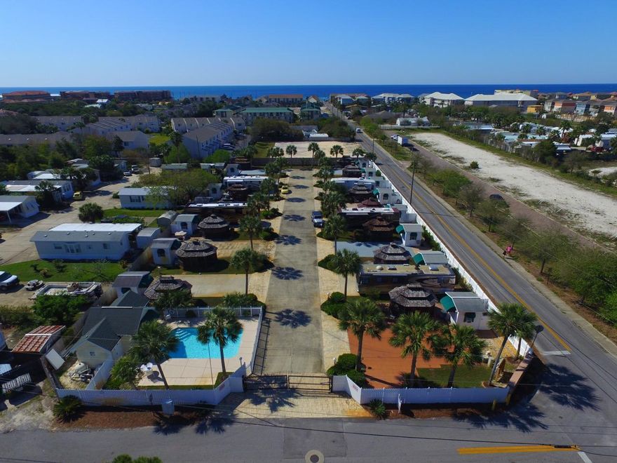 Beachside ''Class A'' Non-Rental Coach/Motor Home Gated Community. Oceanside Community is just two short blocks from the white sand beaches and beautiful Gulf waters. This gated community consists of 15 lots with Palm trees, sprinkler system, Pool and Pool House with Laundry, Restrooms & Shower. This 40x70 Lot comes with a 12x16 updated screened Gazebo, with Satellite, and an 8x10 storage shed. Enjoy maintenance free living at the Beach in this friendly Luxury Community. Just a short walk to restaurants, shopping, bike/walking paths and public Beach Access by Pompano Joe's Restaurant.