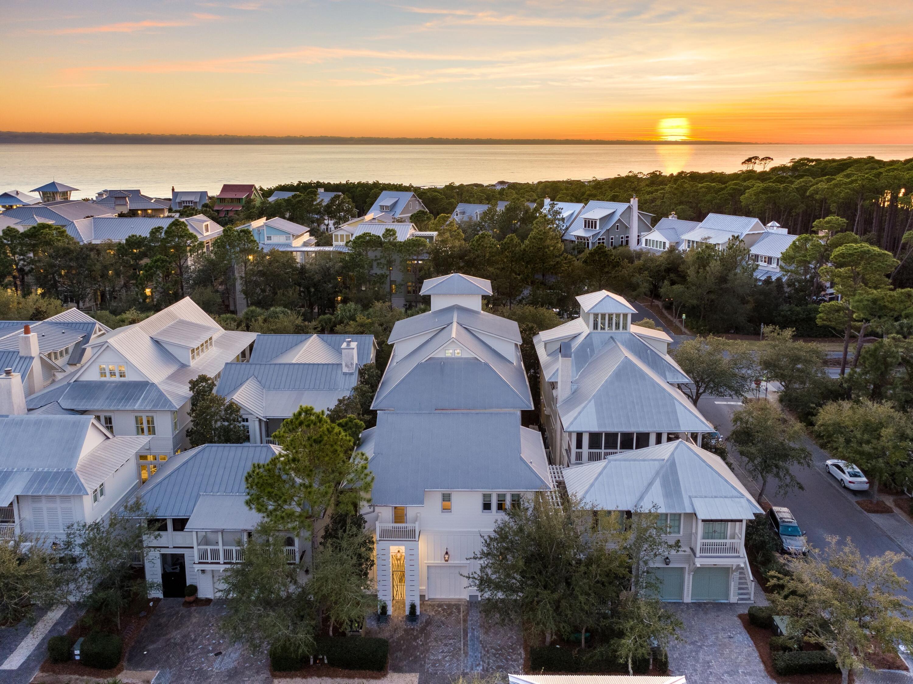 Timeless elegance and luxury await inside this magnificent home and carriage house in beloved WaterColor. Cool whites harmonize with driftwood-finished hardwood flooring while artwork reflects the coastal ambiance embodied in each carefully curated space. Hand-picked furnishings and designer finishes create an enviable living space rarely seen outside the pages of glossy home magazines.