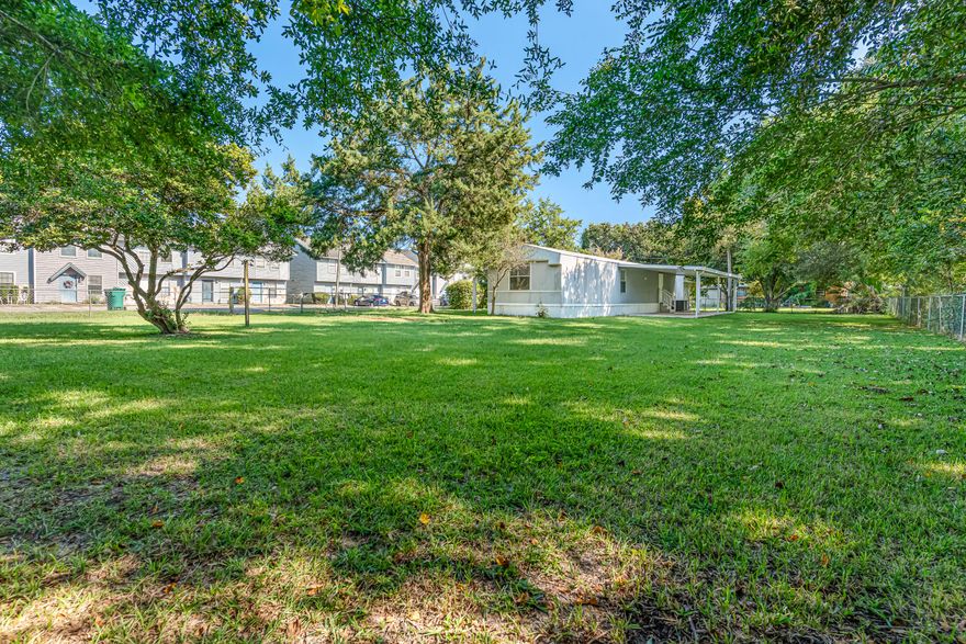 Two-bedroom, one-and-a-half-bath manufactured home in Fort Walton Beach situated on a spacious lot with mature trees and irrigation system. Features include a covered front porch, fully fenced yard, ceramic tile-look flooring, ceiling fans, and abundant natural light. The bright kitchen with white appliances has a washer and dryer conveniently located just off the space. The large primary suite offers a single vanity with tub/shower combo, while the second bedroom includes a walk-in closet. Outdoor storage shed included.
