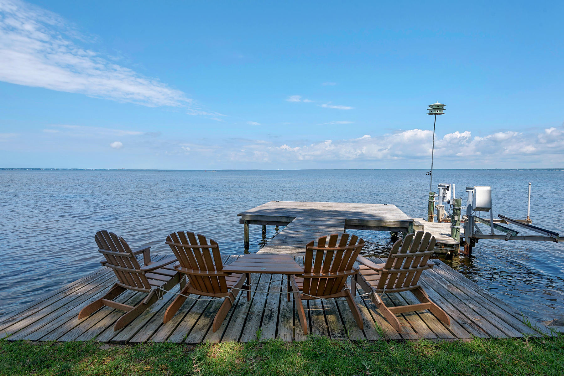 This luxurious home nestled by the serene waters of the Choctawhatchee Bay, offers spectacular sunsets in the prestigious gated neighborhood of Burnt Pine. The open floor plan is ideal for entertaining with incredible bay views from the living room, first floor bedroom and office/media room. The main level opens to a picture-perfect wrap around bayside screened patio. The oversized kitchen with breakfast area offers double ovens, granite countertops, a butler's pantry and gas range. The home is appealing to the most discerning buyer who seeks to have an abundance of amenities including an elevator, private dock with boat lift and 3 car garage. One of this home's most stunning features is the master bedroom, tucked away for privacy, but a generous sitting room opens to an