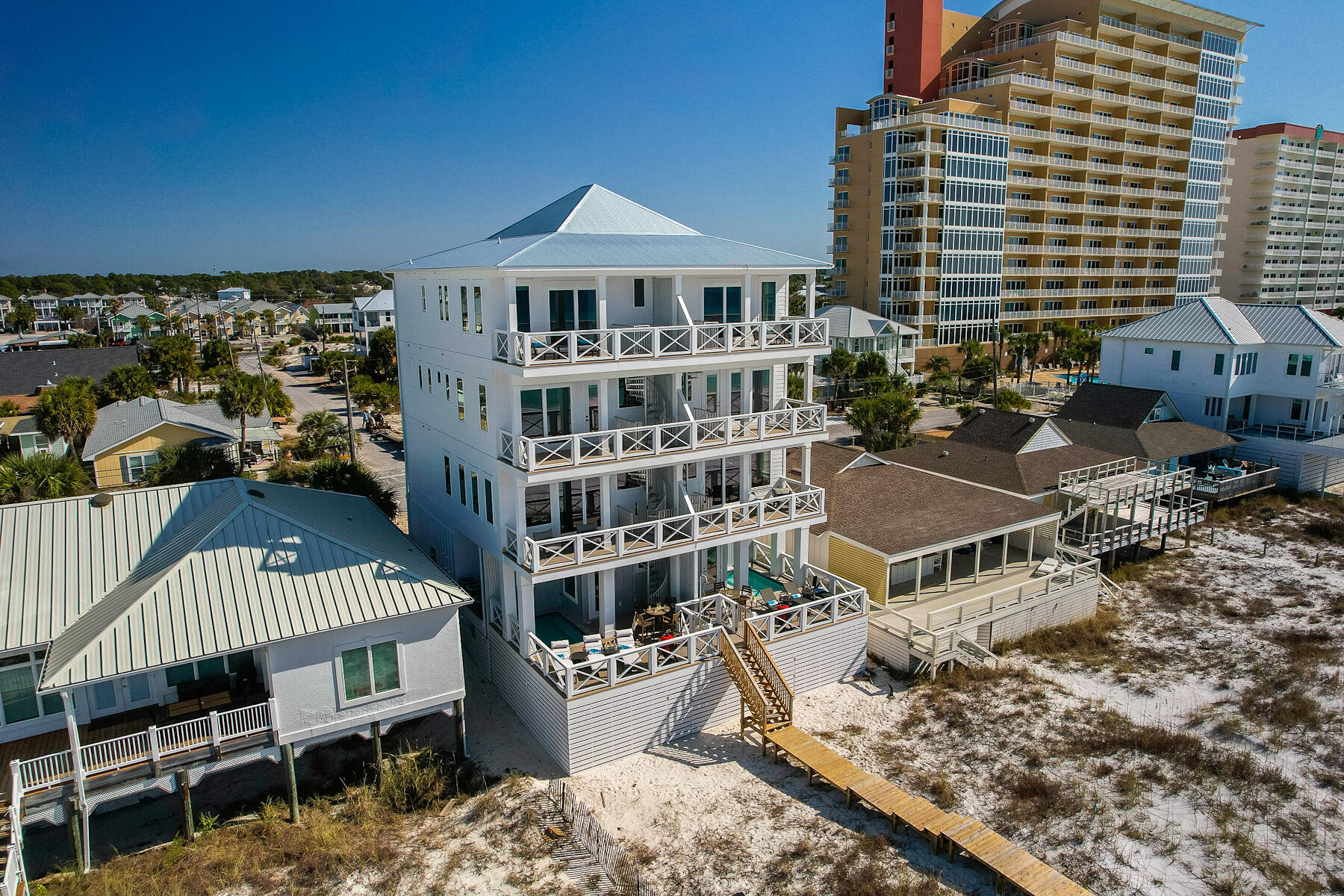 Welcome to this truly stunning luxury beachfront home located on the sugary white sands of the Gulf of Mexico in Panama City Beach. This newer constructed 5 bedroom, 5.5 bath duplex comes fully furnished and can sleep up to 19 guests making it an excellent investment property. The private heated pool with direct beach access is a fantastic addition, providing convenience and relaxation for you and your guests. The open floor plan on the second floor, with its gourmet kitchen and spacious living and dining areas, creates a perfect space for entertaining. The panoramic views of the Gulf of Mexico from the balcony off the living room are breathtaking. The third and fourth floors continue to impress with their well-appointed guest bedrooms and ensuite bathrooms. The custom cabinetry, quartz countertops, and designer tile with frameless shower doors add a touch of elegance to these spaces. The fourth-floor guest bedroom, with its custom-built queen over king bunk beds, offers a unique and comfortable sleeping arrangement. 
The oversized primary bedroom on the fourth floor is a true highlight. With its private balcony and unobstructed views of the beach, it provides a serene retreat. The master bath is equally impressive, featuring a walk-in shower, freestanding soaking tub, quartz countertop with dual vanity, and custom cabinets. 
Additional features like hurricane impact windows and doors, upgraded lighting fixtures, tankless hot water heaters, and multiple decks enhance the overall appeal and functionality of this gorgeous home. 
Overall, this property offers a luxurious coastal living experience with its stunning design, high-end finishes, and convenient amenities. It would surely be a dream home for anyone looking to enjoy beachfront living.
