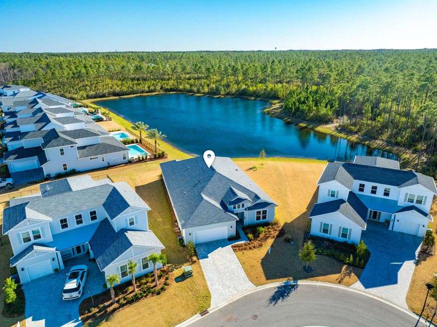 Welcome to 2552 Pathways Drive -- a stunning new construction home nestled in the heart of WaterSound Origins, the most sought-after gated community along Scenic 30A in Inlet Beach, FL.This is not your standard build. Featuring a specially expanded floor plan, this exceptional 3-bedroom, 3-bathroom residence was designed to deliver a grander and elevated living experience from the moment you arrive. Step through the grand entry foyer and immediately feel the difference. Soaring high ceilings, rich engineered hardwood floors, premium interior finishes, and a spacious open-concept layout that flows effortlessly throughout the home. A versatile office/media room offers the flexibility to function as a 4th bedroom, adapting perfectly to your lifestyle needs. The large chef's kitchen is the heart of the home, designed for both everyday living and effortless entertaining. Every detail reflects the care and craftsmanship that went into this specially curated, expanded design -- from the engineered hardwood floors underfoot to the elevated finishes that set this home apart from anything else in the community.
The bathrooms are nothing short of luxurious. Each is beautifully tiled with features like sleek rimless glass enclosure, elevating the everyday experience. The expanded primary bathroom is a true sanctuary -- a spa-inspired retreat featuring a luxurious walk-in shower with a rimless glass enclosure. The primary bedroom boasts stunning panoramic lake views that transform your morning routine into something truly extraordinary. This is the kind of primary suite you'd expect at a five-star resort, right in your own home.
Step outside and experience the ultimate backyard setting -- an oversized covered porch perfectly positioned to frame peaceful lake views, lush nature, towering trees, and those breathtaking Florida sunsets. With ample yard space ready for a custom pool, the outdoor living potential here is simply unmatched.
Beyond your doorstep, WaterSound Origins delivers resort-style living at its finest -- featuring a Village Commons with a resort pool, fitness center, sports courts, parks, and scenic walking trails, plus direct access to Lake Powell with complimentary kayaks for residents. The Origins Golf Club is right within the neighborhood, and the growing WaterSound town center -- complete with a Publix, restaurants, and shops -- is just minutes away.
