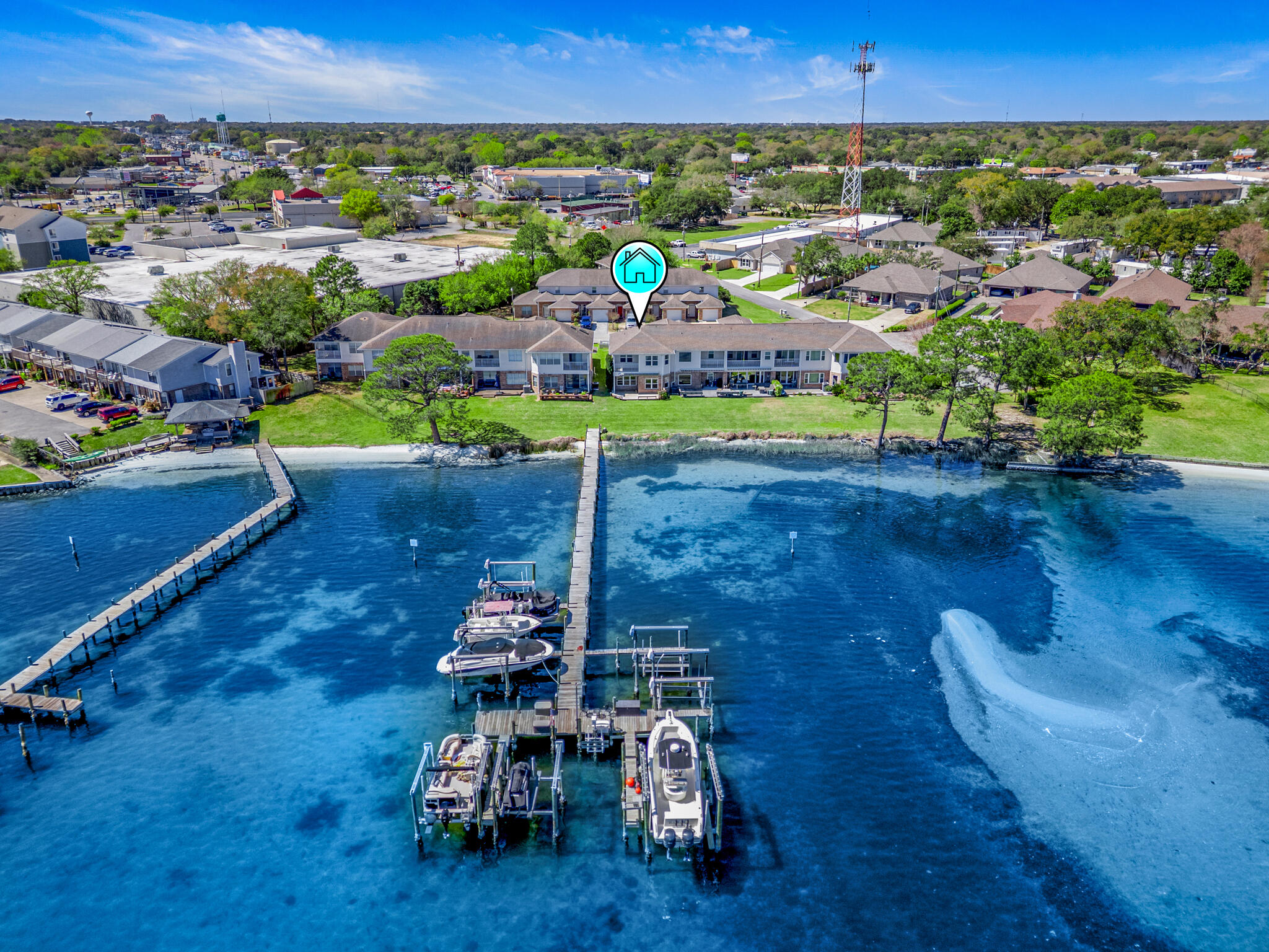 Price Improvement! Additional $10,000 Flooring Credit! Near shopping, restaurants, beaches and bases, this end-unit waterfront townhome perfectly balances convenience and serenity. The open-concept living area on the main floor offers stunning sweeping views of Garnier's Bayou and opens onto a spacious deck--perfect for relaxing and entertaining. This property is a boater's dream with a deeded boat slip and boat lift. There are 9-foot ceilings throughout, and upstairs 3 bedrooms feature trey ceilings. The roomy master suite overlooks the water and has a balcony, ideal for enjoying peaceful sunrises. Other highlights include custom maple kitchen cabinetry with granite countertops and breakfast bar, generous storage, crown molding, a 2-car garage with paver driveway, and low HOA fees. Live the waterfront lifestyle!