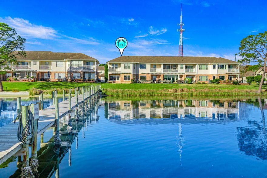 Price Improvement! All NEW Luxury Vinyl Plank and Carpet Flooring (interior photos coming soon!). Near shopping, restaurants, beaches and bases, this end-unit waterfront townhome perfectly balances convenience and serenity. The open-concept living area on the main floor offers stunning sweeping views of Garnier's Bayou and opens onto a spacious deck--perfect for relaxing and entertaining. This property is a  boater's dream with a deeded boat slip and boat lift. There are 9-foot ceilings throughout, and upstairs 3 bedrooms feature trey ceilings. The roomy master suite overlooks the water and has a balcony, ideal for enjoying peaceful sunrises. Other highlights include custom maple kitchen cabinetry with granite countertops and breakfast bar,  generous storage, crown molding, a 2-car garage with paver driveway, and low HOA fees

Live the waterfront lifestyle!