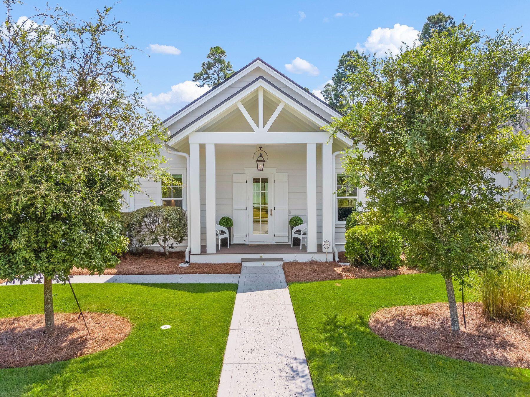 Step into one of Origins' most sought-after Romair Custom Homes - an elegant single-level retreat designed for effortless living and unforgettable entertaining. This exceptional residence features an expansive open floor plan, a generous double garage plus a separate golf cart garage, and an outdoor oasis complete with cabana, fireplace, summer kitchen, shimmering pool, and spa. Perfectly positioned on a prime corner lot adjacent to a serene pocket park and community buffer, this home offers a rare blend of privacy and tranquility. Inside, every detail was thoughtfully curated by RH Design Group, creating a seamless flow of style and sophistication from room to room. Beyond the welcoming foyer, a stunning vista reveals the open Living, Dining, and Chef's Kitchen - where a wall of sliding glass doors blurs the line between indoor and outdoor living, leading to the screened porch overlooking your private paradise. The Chef's Kitchen boasts a Wolf/SubZero appliance package, a stylish bar with wine cooler, and impeccable finishes for the ultimate culinary experience. With no stairs and minimal hallways, the layout maximizes both elegance and ease. The sprawling Master Suite anchors one side of the home, while guest bedrooms and a dedicated office offer comfort and versatility on the other. Built in 2020 and thoughtfully upgraded throughout, this home is ready for its next chapter - make it yours.