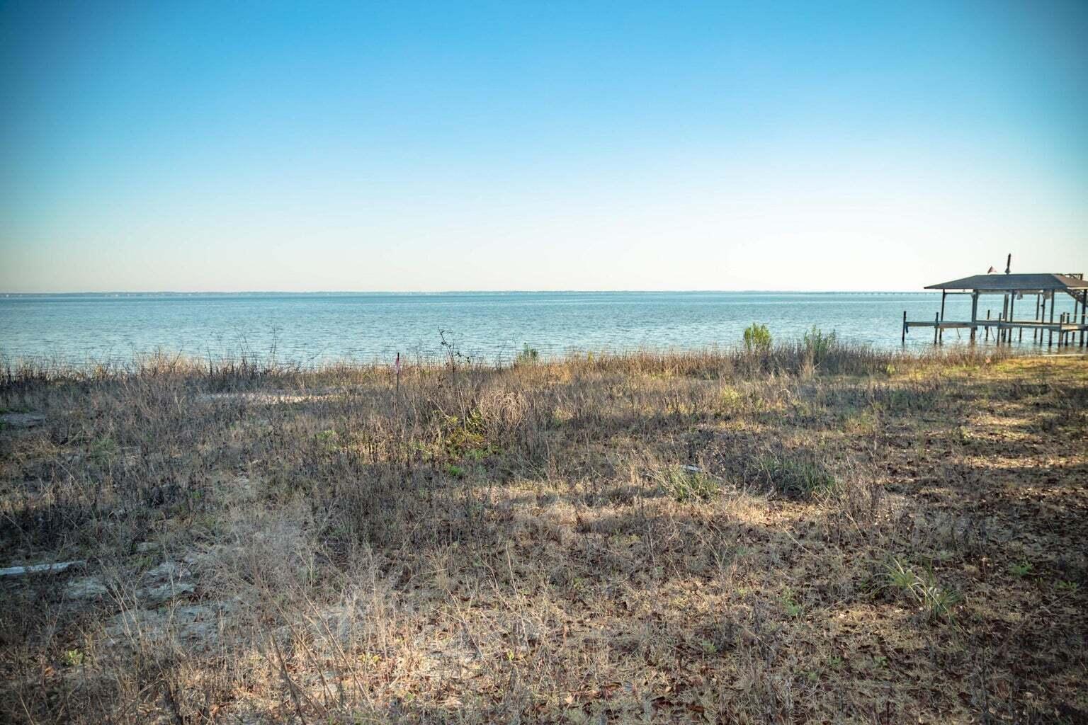 Two ideally located vacant lots being sold together boasting approximately 0.68 acres. These primely positioned lots have +/- 96 bay front feet with a seawall and riprap in place. Close proximity to popular restaurants such as The Bay and Southern Farm & Fire. Only eleven minutes from the beach on Scenic Highway 30a with beautiful bay views and ample space for building your primary residence or second home. There is no HOA associated with these lots. The maximum square footage that can be built on both lots is 7360 sq ft (4130 and 3230 per lot). This exemplary build site is elevated and dry with an unobstructed view of the Choctawhatchee bay. A fantastic opportunity to build in North Santa Rosa Beach. Parcel IDs 24-2S-20-33030-001-0020; 24-2S-20-33030-001-001A