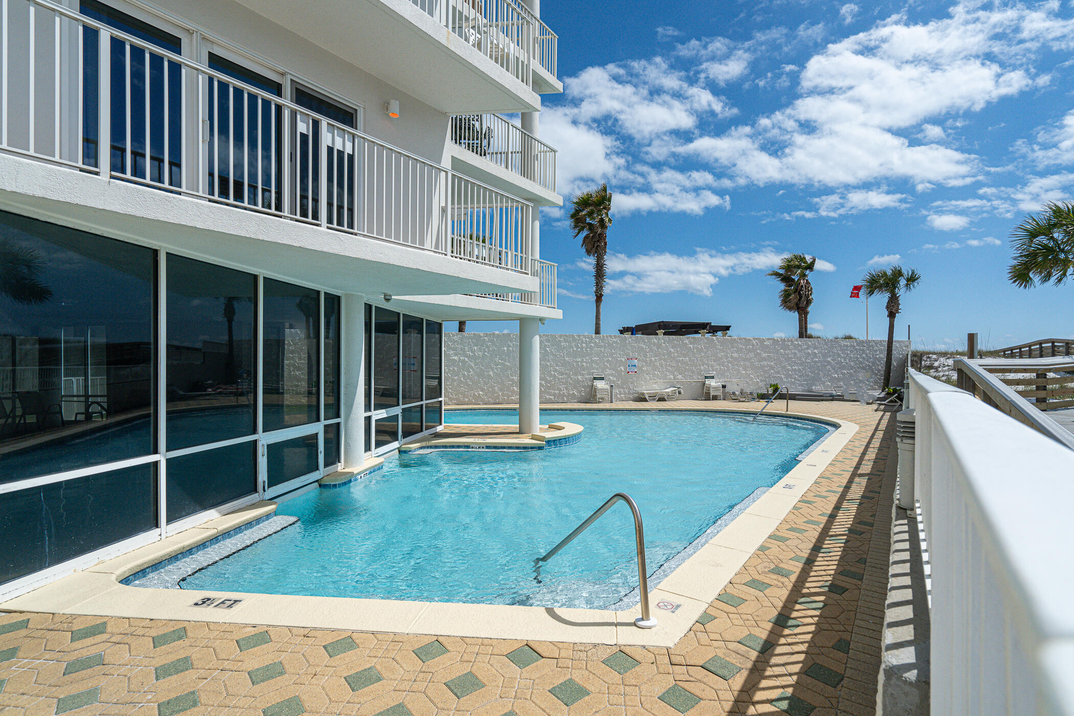 Price drop! Do not miss this one--see it now! Situated on the Gulf of Mexico, this 2 bedroom, 2 full bath condo is perfect for your next holiday. Convenience is essential with an assigned covered parking space for you. It's a short walk to the Gulf to enjoy the sandy white shore and emerald water. Indulge in this property's luxurious amenities: a heated indoor pool, an outdoor pool, a gym, barbecue grills, and a picnic table. Whether you want to relax or stay active, this condo has something for everyone. This property can be short-term rented, so schedule your tour today!