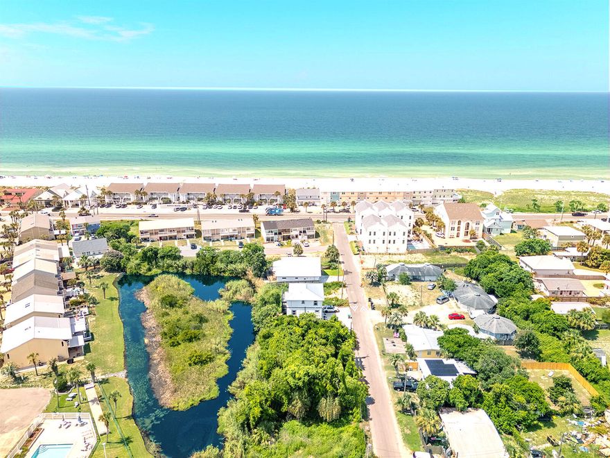 BUILDABLE LAND OPPORTUNITY! Pulling permits and tap fee paid. Located on the scenic West End of the beach, this exceptional pond-front double lot is perfect for investors, builders, and dreamers alike. Spanning 50'x90', this R2-zoned lot accommodates a single-family home or duplex, with potential for Gulf views from multi-level builds. Owner financing is available, making this a rare chance to capitalize on coastal living. Enjoy tranquil pond views, breathtaking sunsets, and easy access to Laguna Beach--no flood insurance required! Water and sewer lines are ready for hookup, simplifying the building process. Additional land is available for even greater potential. Opportunities like this are limited--act now to secure your piece of paradise. Contact us today for details, surveys, and more!