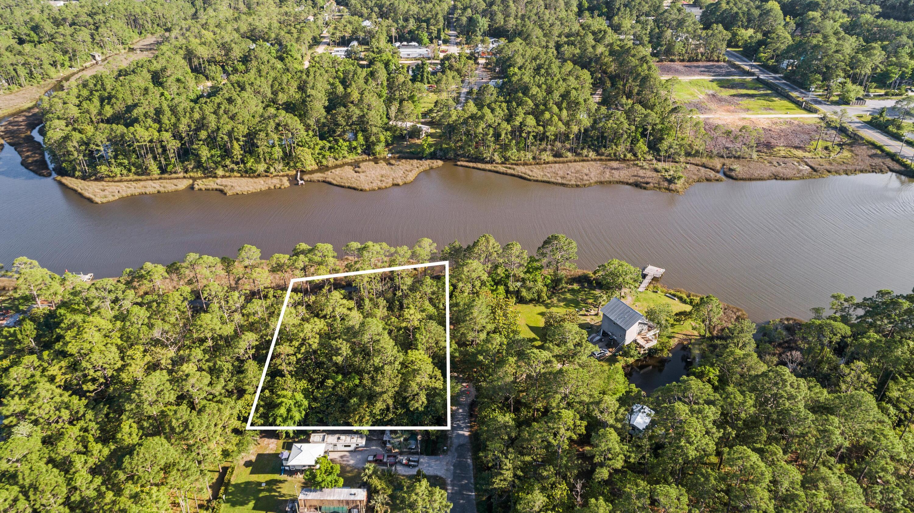 Beautiful wooded lots located within five miles of the beach and only three minutes to 30a! in close proximity to shopping and dining in the heart of Santa Rosa Beach. Build your waterfront home with 125ft of waterfront with no HOA. Water and sewer available at street. Don't miss this opportunity to own on Hogg Town Bayou! motivated Seller with reasonable offers considered.