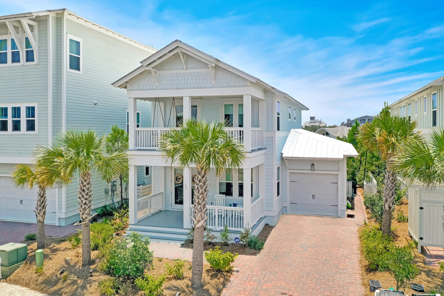 Meticulously cared for, this attractive beach house backs up to a forever green buffer and the Watersound Beach neighborhood. As you approach the home, notice the deep and inviting front porch. A total of three porches provide almost 1,000 square feet for enjoying the outdoor lifestyle in this peaceful part of the community. This light and spacious home has an open floor plan incorporating a living area with shiplap accents and a dining table to seat eight. Engineered hardwood flooring emphasizes the high quality showcased throughout this pristine home. Heading toward the kitchen, three bar stools are lined up at the peninsula for casual dining or pre-dinner drinks. The kitchen has lots of counter space, maple cabinetry, built-in stainless steel appliances and a five-burner gas range with vented hood. The first-floor master suite boasts an immaculate ensuite bathroom paired with a rain head shower, dual vanities and a walk-in closet. The back door leads out to a generous screened porch and a grill area within the fenced yard. A half bathroom, laundry, and storage closets complete the well-planned main level living space. Upstairs there's a king-sized bedroom with an ensuite bath and large walk-in closet. Two more guest bedrooms share the family bathroom and both have direct access to the generous second-floor porch. It's a lovely space to enjoy a cup of coffee or a quiet read on the swing seat. The one car garage offers bike storage and overhead racks. This home has never been rented out but is in a prime location for vacation rentals. Located on the quieter south side of the Prominence neighborhood, it's conveniently close to The Big Chill for dining, shopping and entertainment. With two community pools, a fitness room and the beautiful white sandy beach nearby, it has all the makings of a perfect primary residence or vacation home.